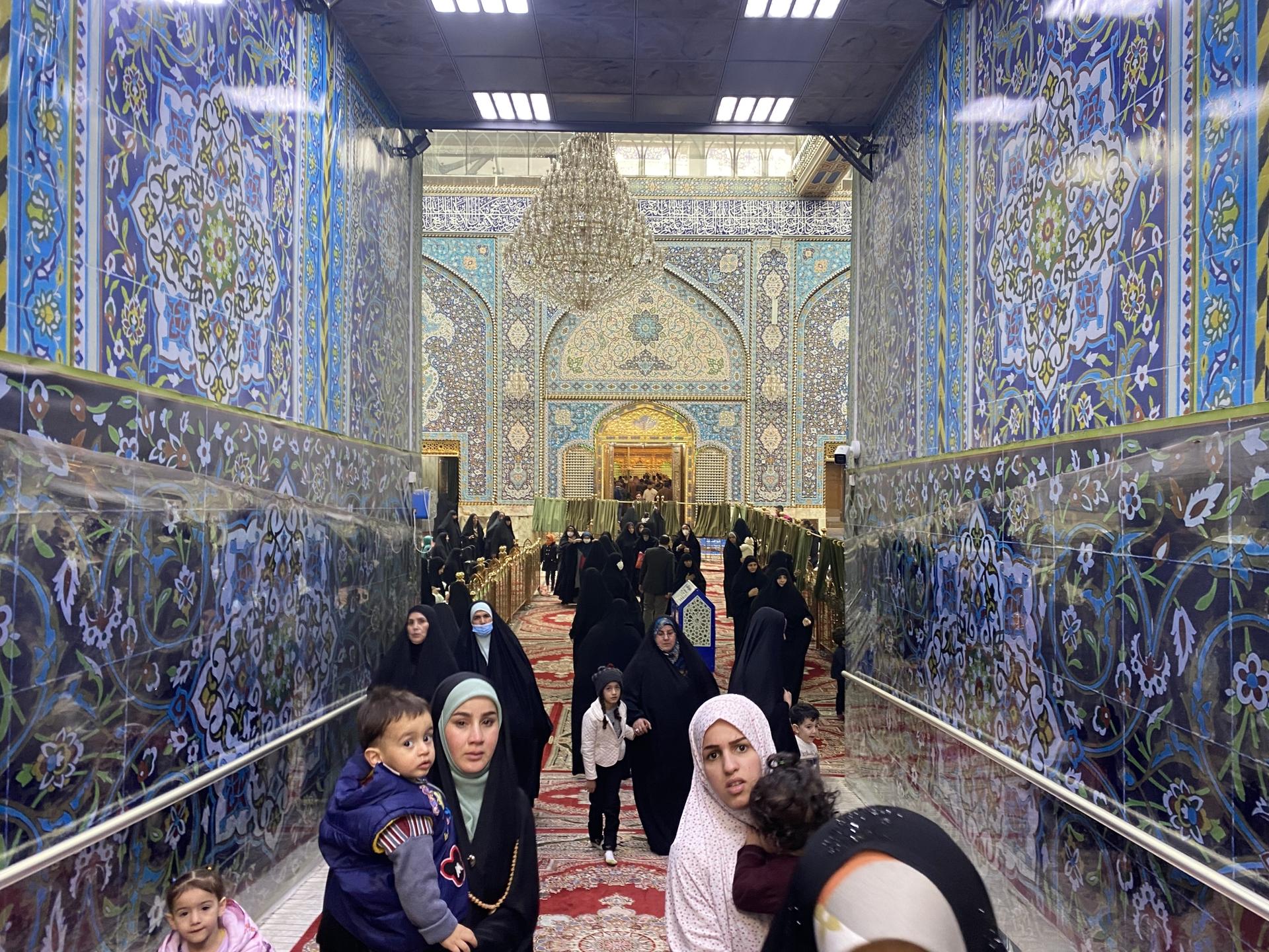 Women and children stream out of the Imam Abbas shrine in Iraq’s holy city of Karbala on Dec. 7, 2021.