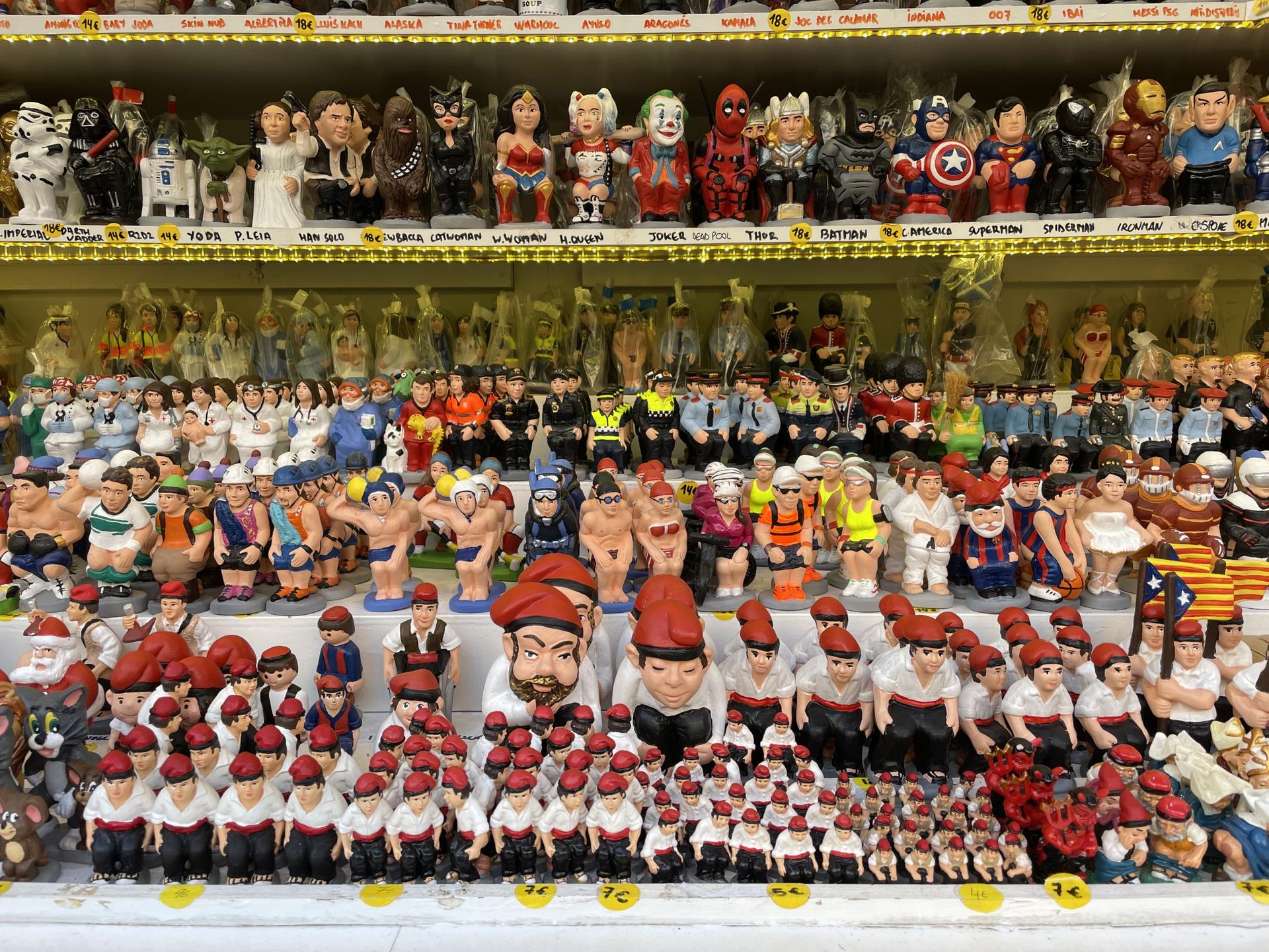 A Caganer, which means "pooping person," is placed on nativity scenes in Catalonia. While they're originally depicted as peasants, vendors now sell all kinds of characters.