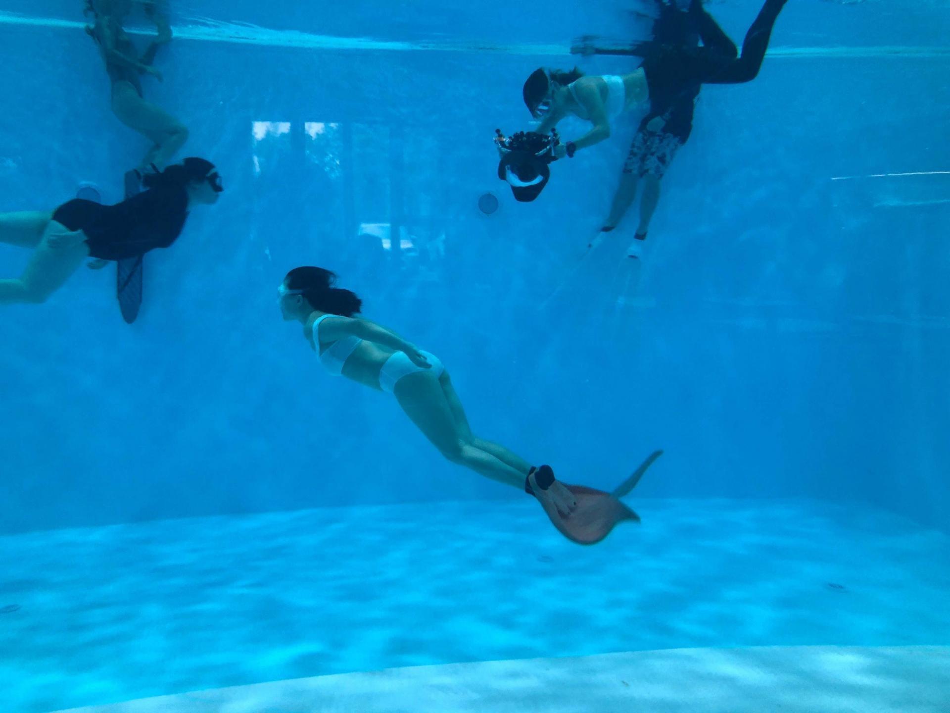 Instructor Rachel Wang takes photos of student Christina Bao under the water. 