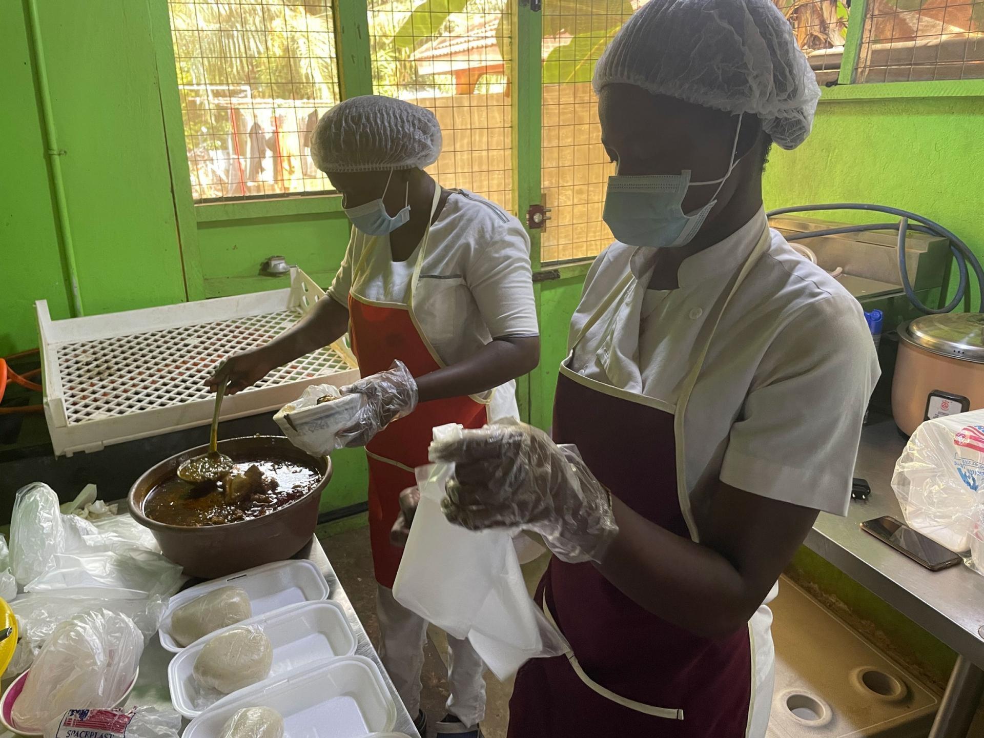 The Food for All Africa team dishes out meals into packs to distribute to people in need. 