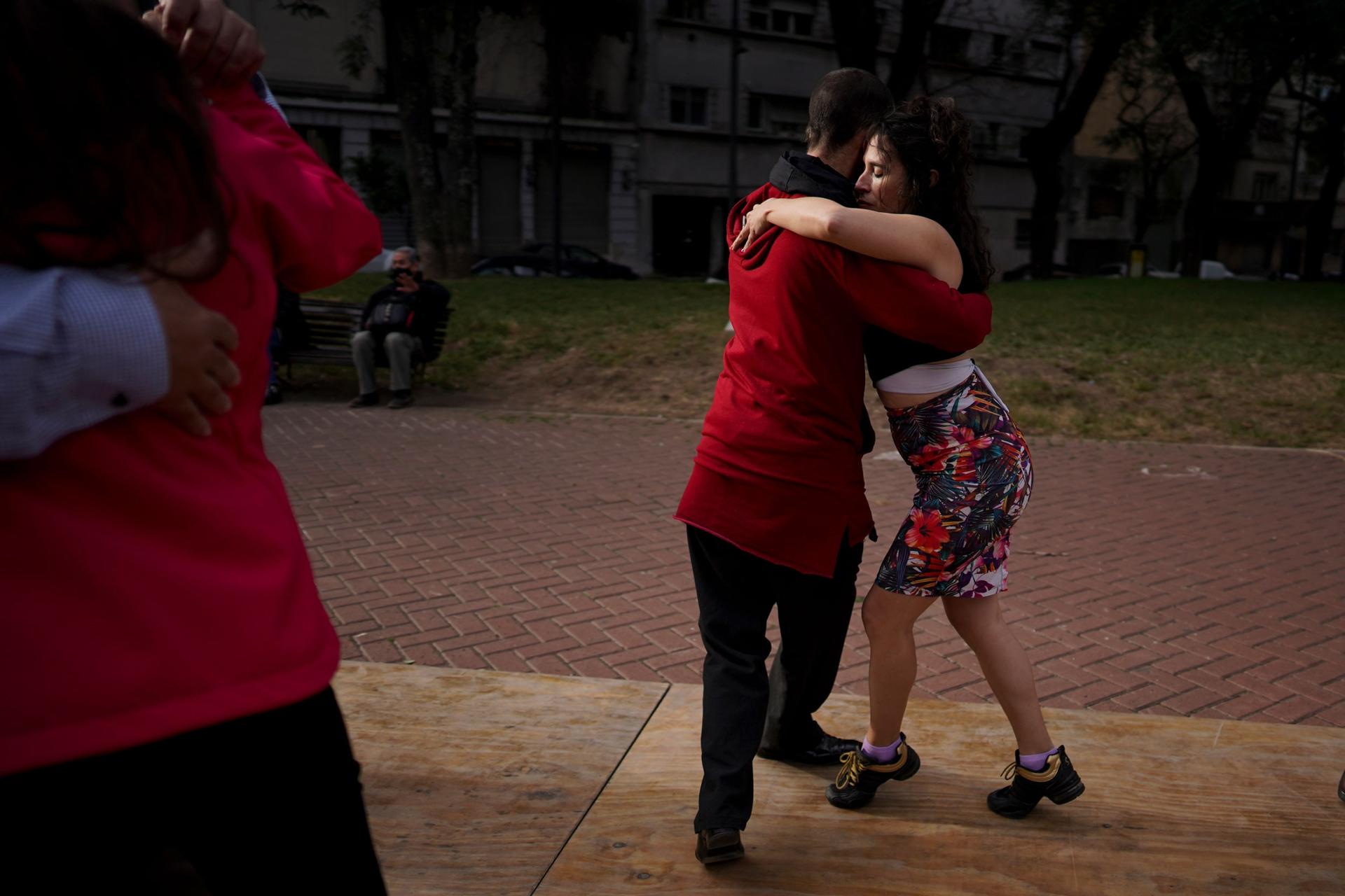 In this June 6, 2021, file photo, a couple dances tango at a park amid the COVID-19 pandemic lockdown in Buenos Aires, Argentina. 