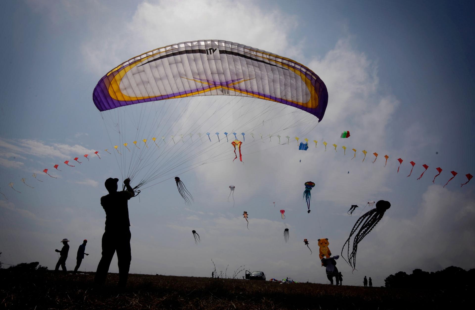 A man is flies his kite during the First Varvara Kite Fest in the village of Varvara on Bulgarian Black Sea coast, Friday, Aug. 27, 2021. 