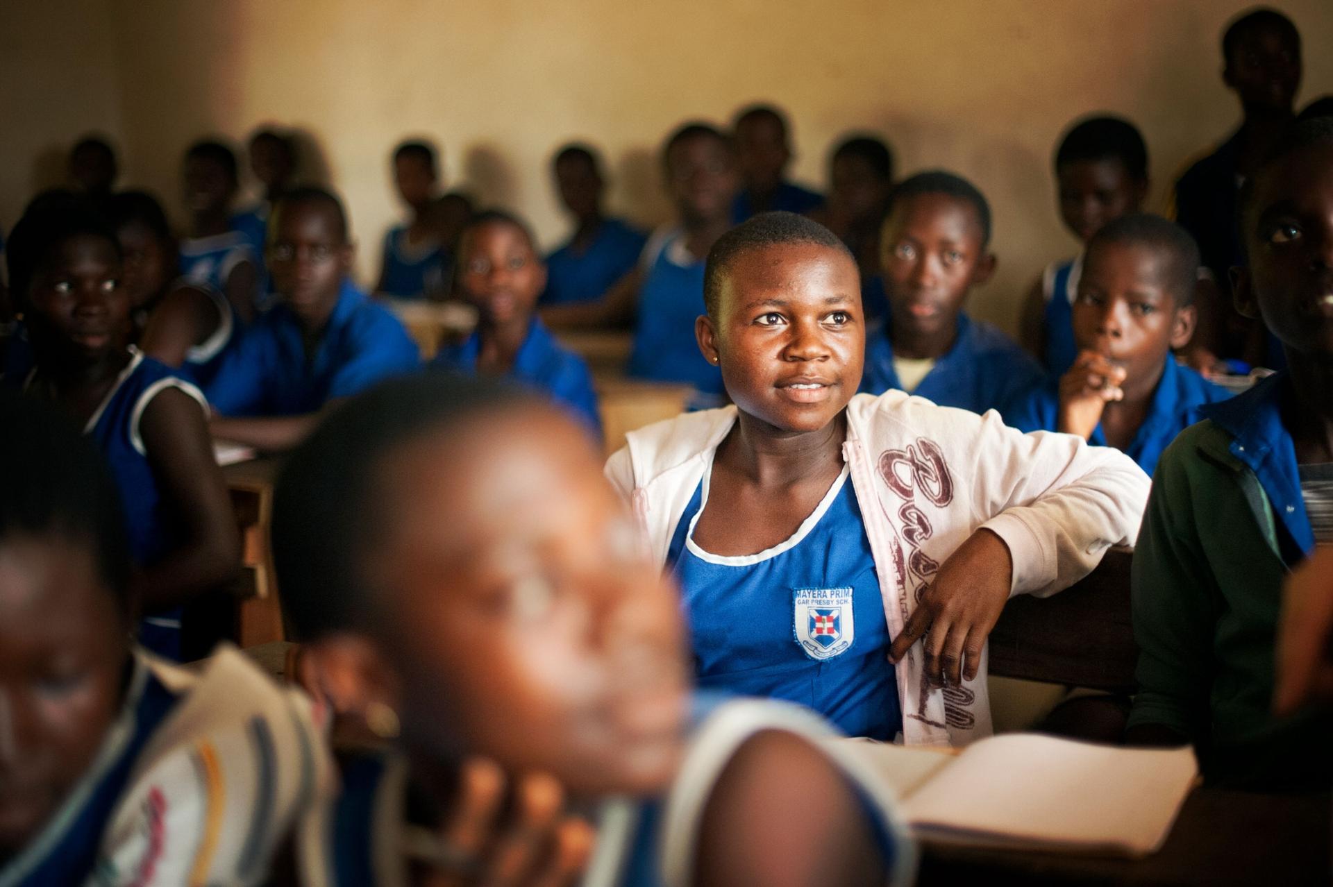 A girl sits in a classroom in Ghana. During the pandemic lockdowns, many youth missed out on free lunches provided at school, making them more vulnerable to exploitation. 