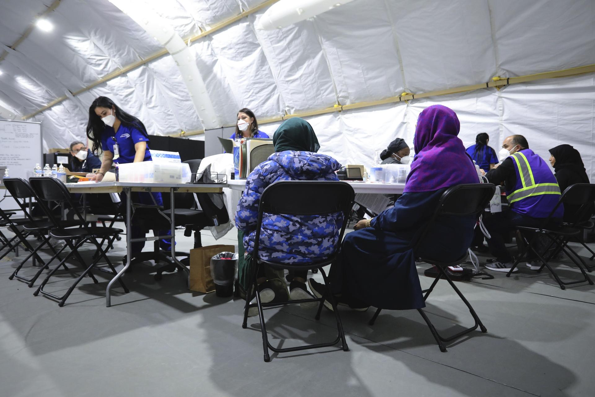 Afghan refugee women register to be seen by a doctor inside the medical tent at Liberty Village on Joint Base McGuire-Dix- Lakehurst, New Jersey, Dec. 2, 2021. 