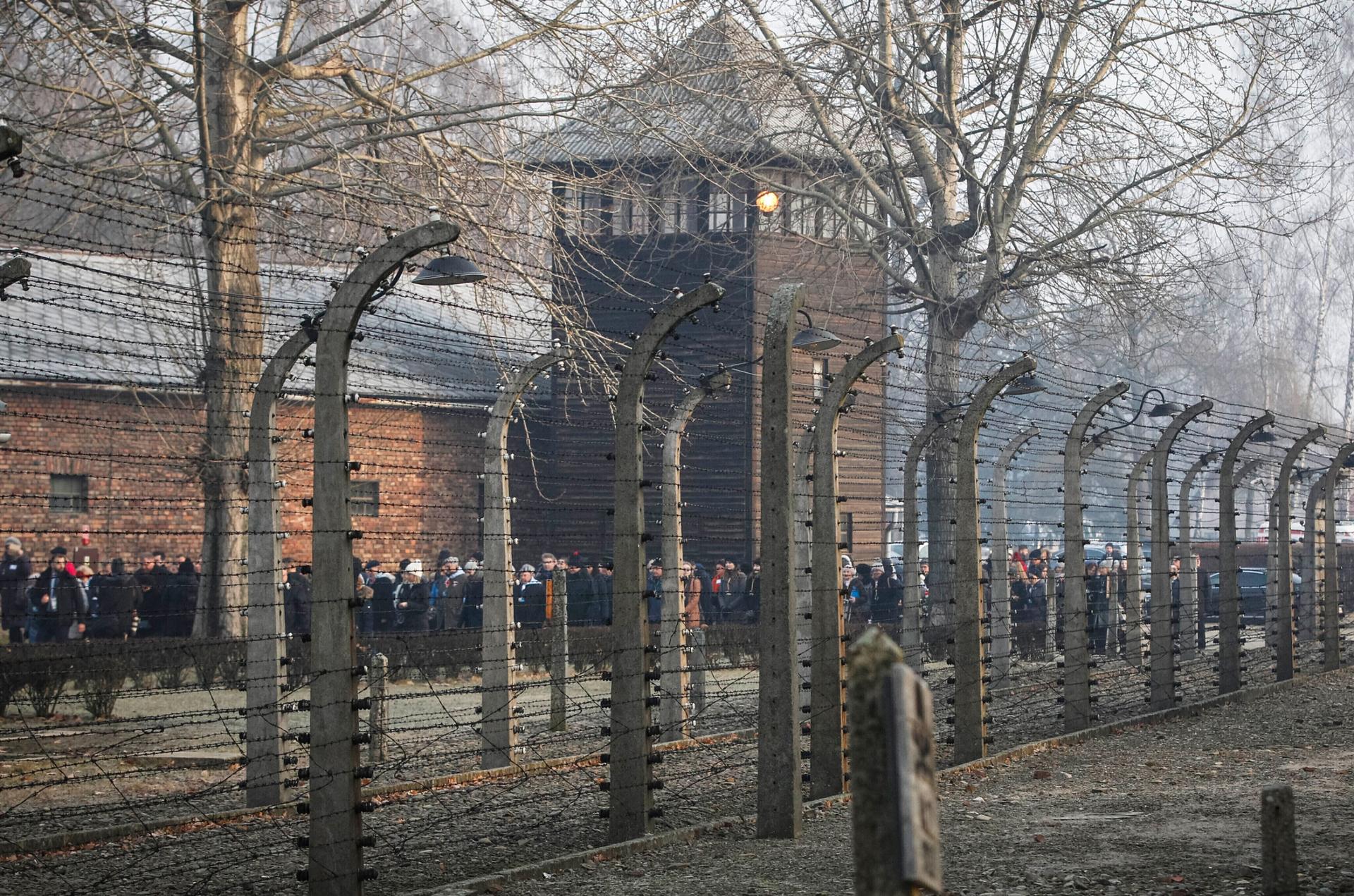People are seen arriving at the site of the Auschwitz-Birkenau Nazi German death camp, where more than 1.1 million were murdered, in Oswiecim, Poland, Jan. 27, 2020. 