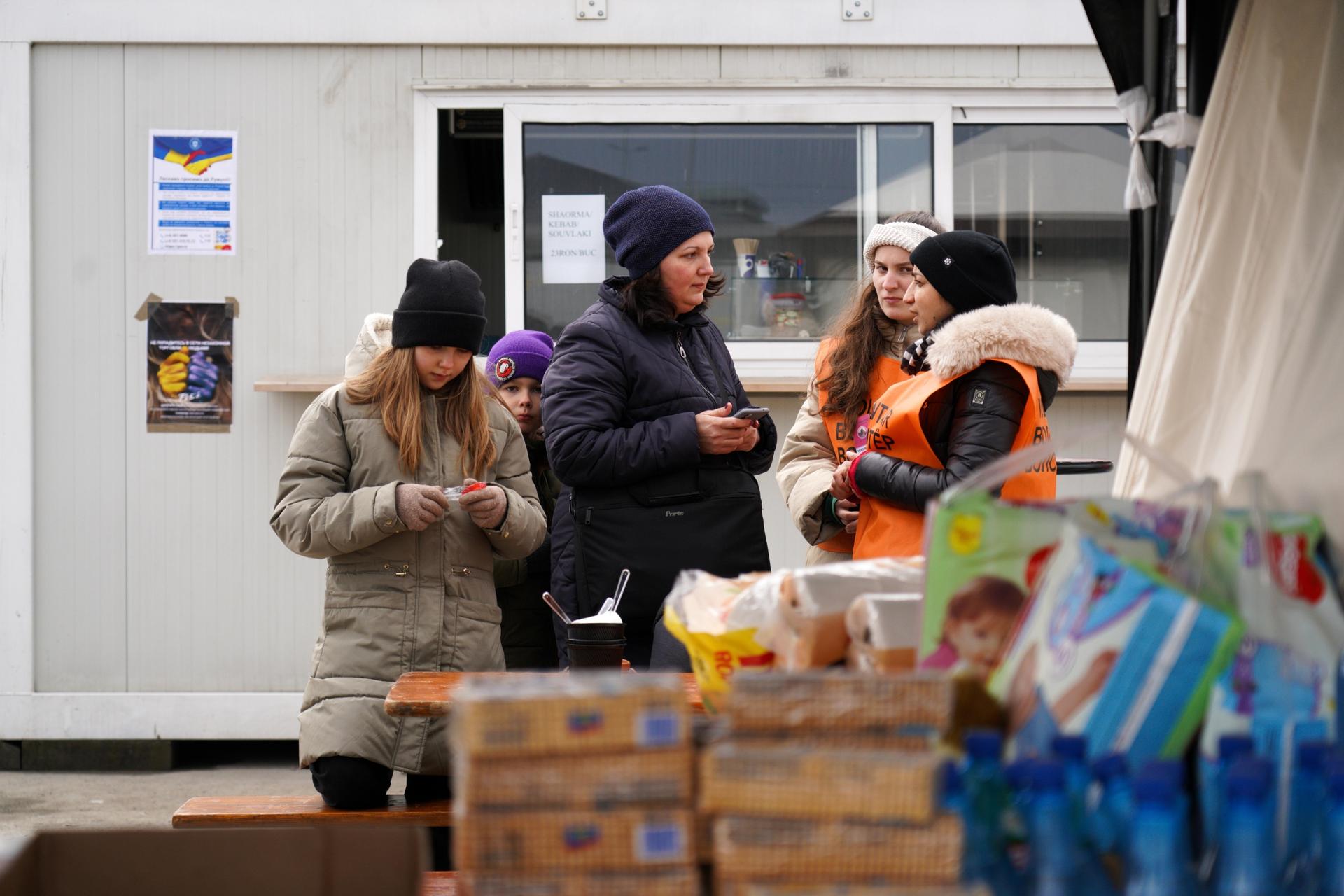 Once at customs in Isaccea, alone, on Romania’s southern border, refugees are directed to inflatable orange tents serving hot tea and sandwiches while they wait to go through passport control.