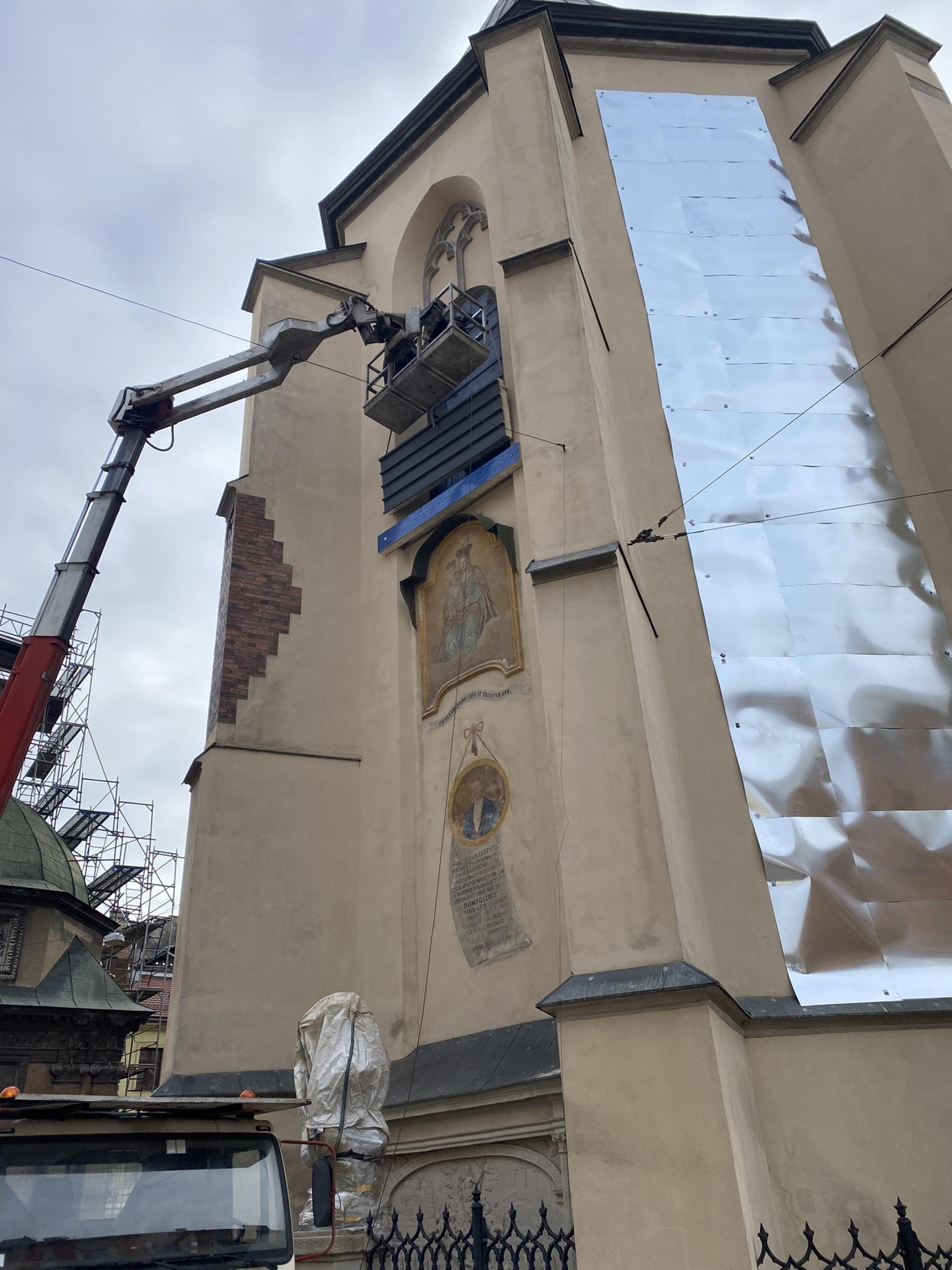 Workers install steel plates onto Lviv's 14th century central basilica to protect against potential Russian attack