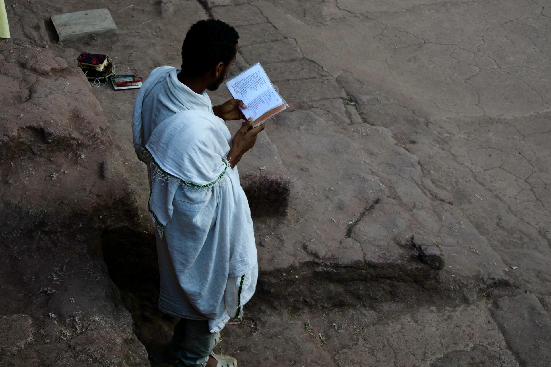 Young man prays at the Lalibela rock churches in Ethiopia, Feb. 16, 2022.