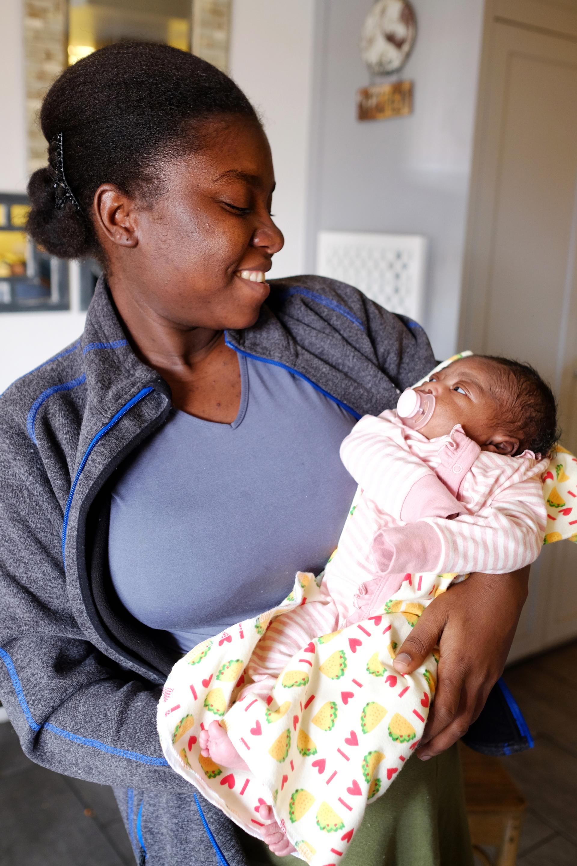 Dieula Sainvil holds her newborn baby at a shelter in the west Phoenix area where she's staying.