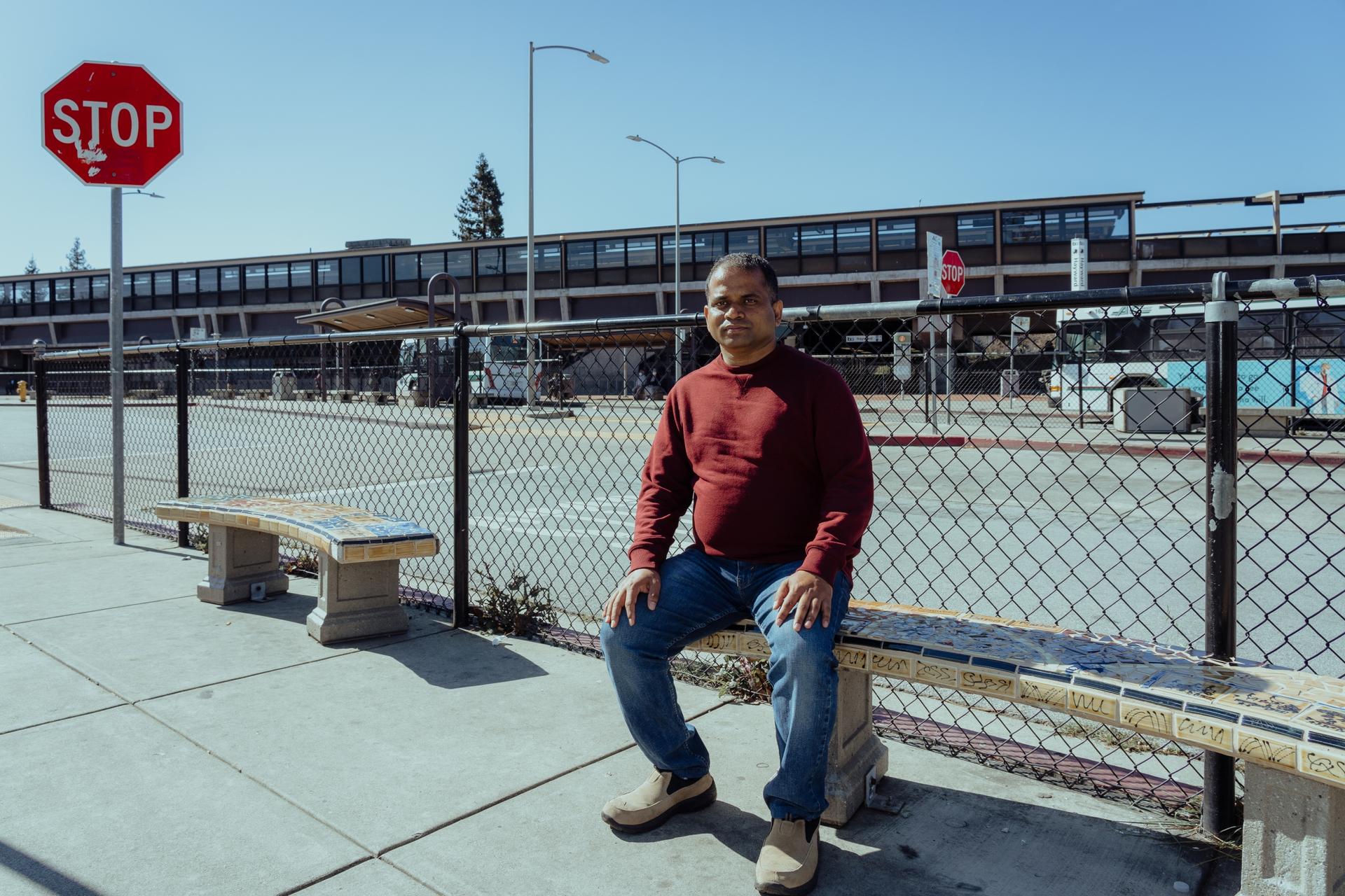 man on a bench at a train station 