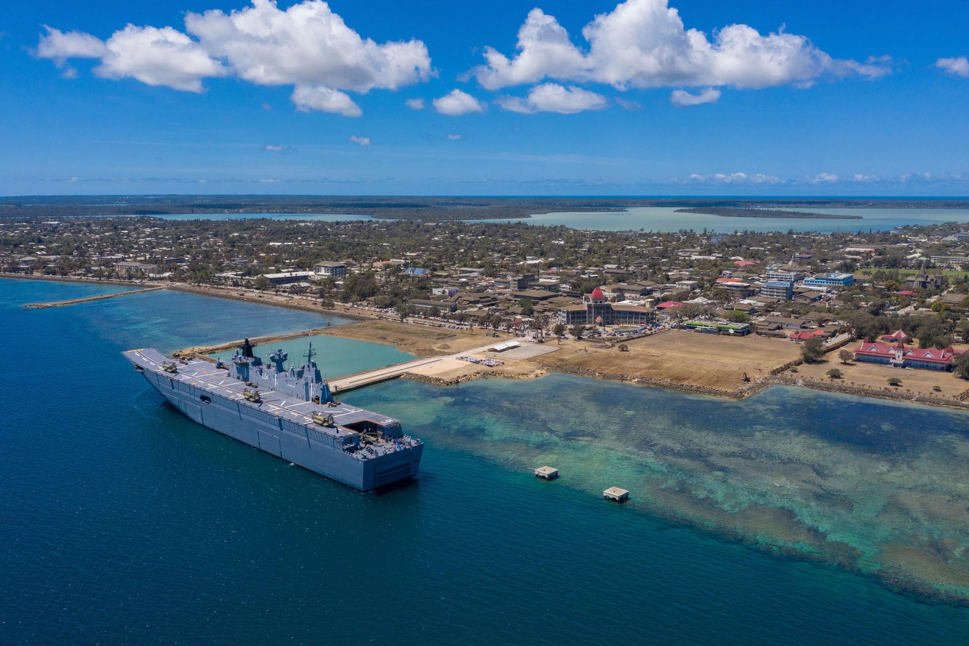 In this photo provided by the Australian Defense Force, HMAS Adelaide is docked at Nuku'alofa, Tonga, Thursday, Jan. 27, 2022, after carrying disaster relief and humanitarian aid supplies. 