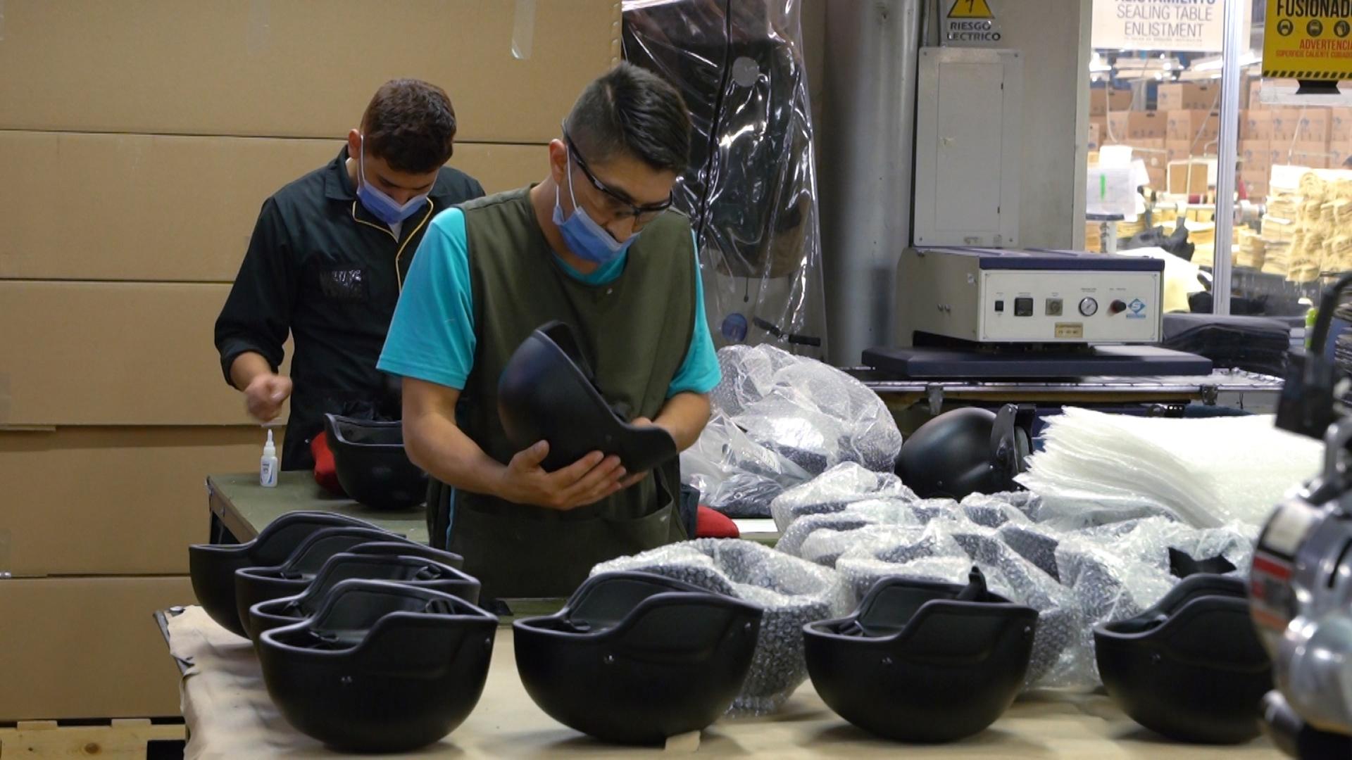 Employees at the MC Armor plant in Bogota, Colombia, work with helmets and other gear meant to protect people especially in conflict and war zones.