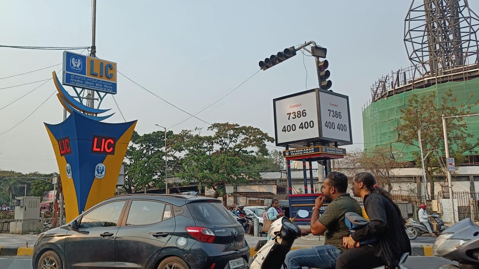 The blue and yellow LIC logo is seen on a traffic island in Hyderabad in southern India. The government-owned company is India's biggest insurer. Its upcoming IPO is set to be India's largest ever. 