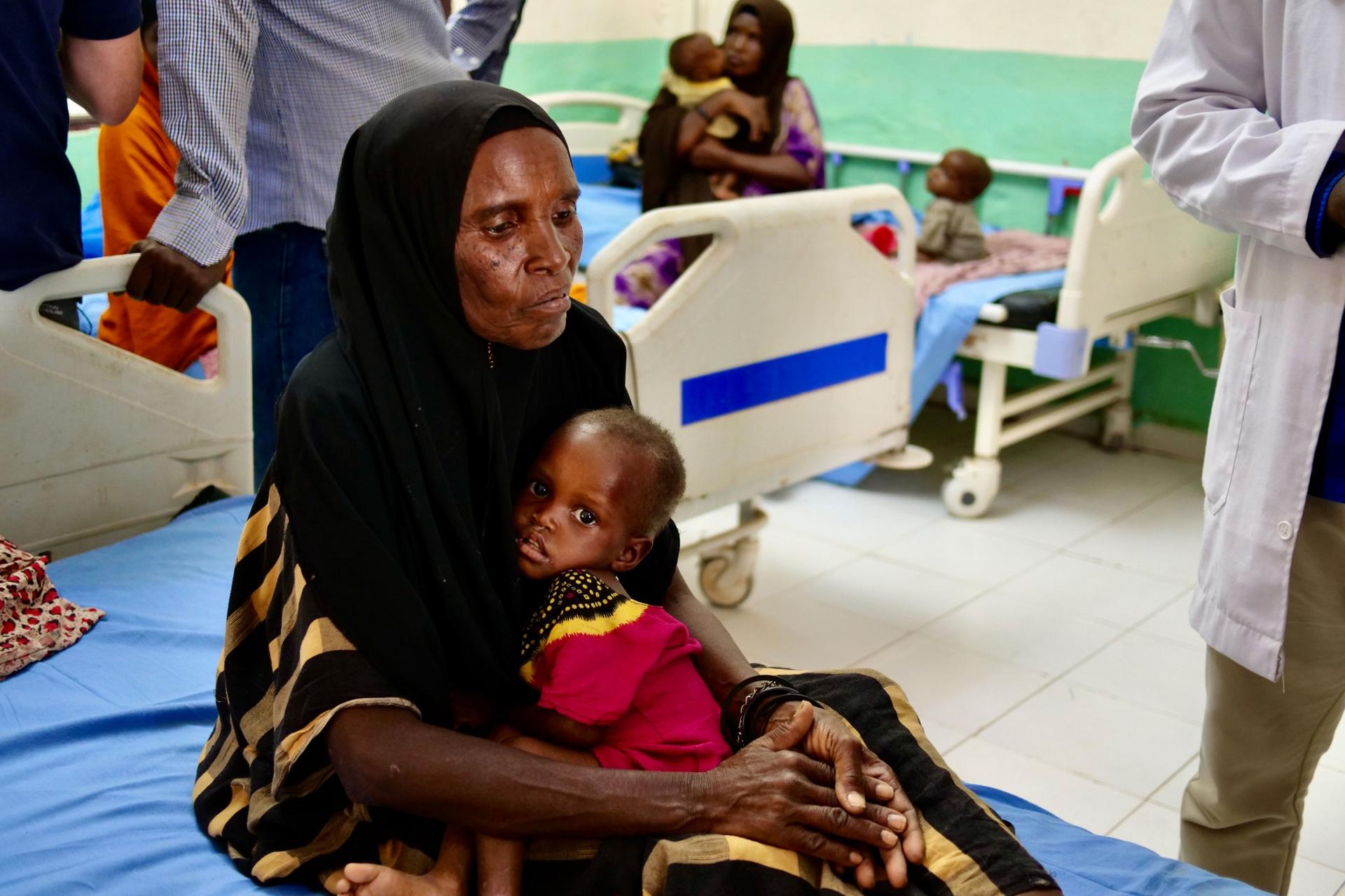 Barow Hassan holds her 2-year-old granddaughter, who is malnourished, at a hospital in Luuq, Somalia, March 21, 2022. 