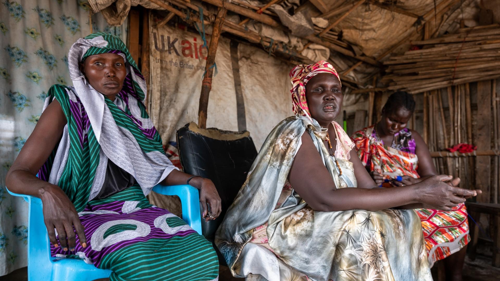 Margaret Nyakhor sits with a friend at a tea spot in a camp for internally displaced people in Juba, South Sudan.