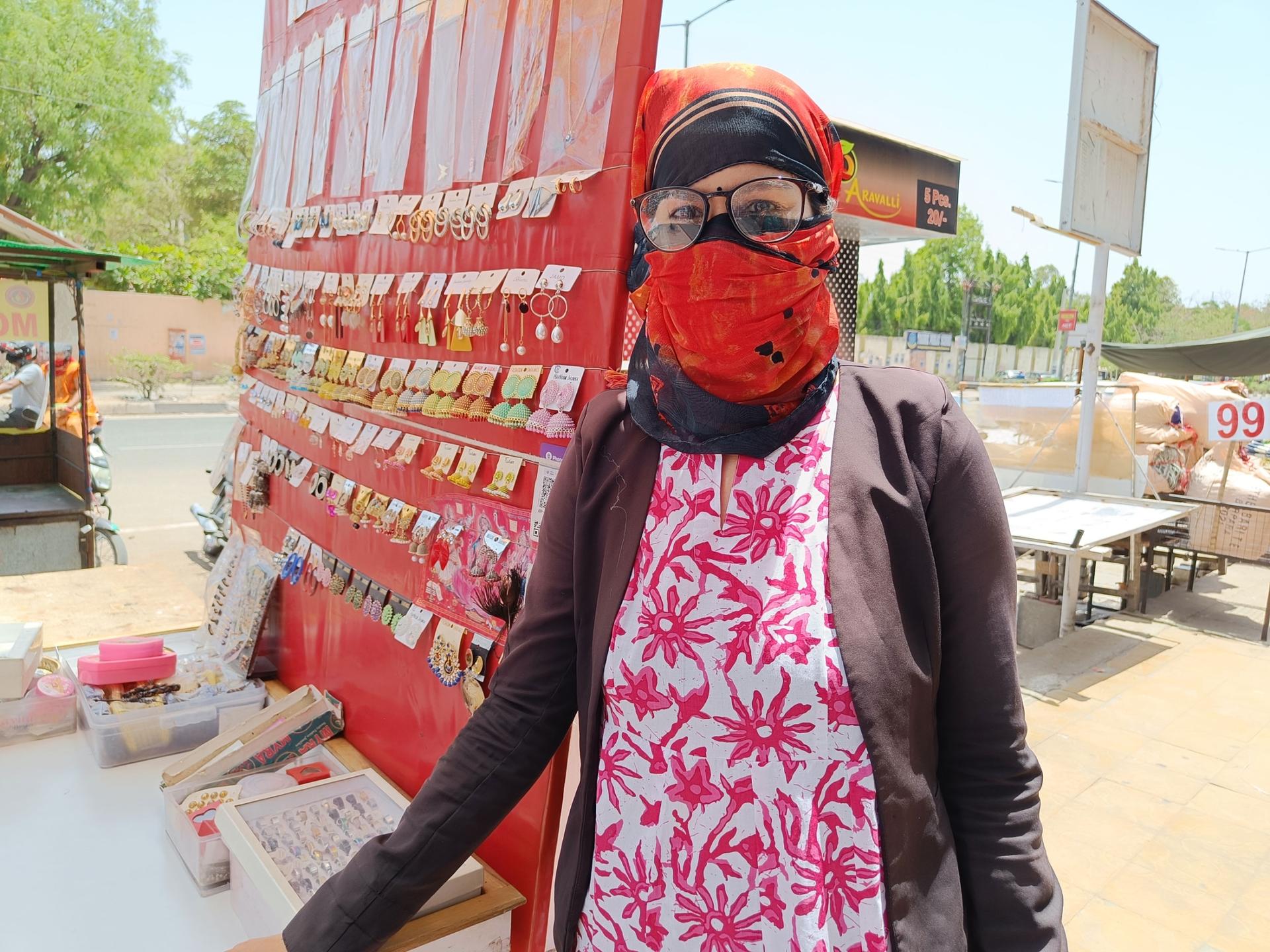 Jyoti Jain is one of the few shoppers at a market in Jaipur in northern India. She uses a face and head covering and wears a full-sleeved shirt to protect herself amid a severe heatwave that's gripped India in recent weeks.