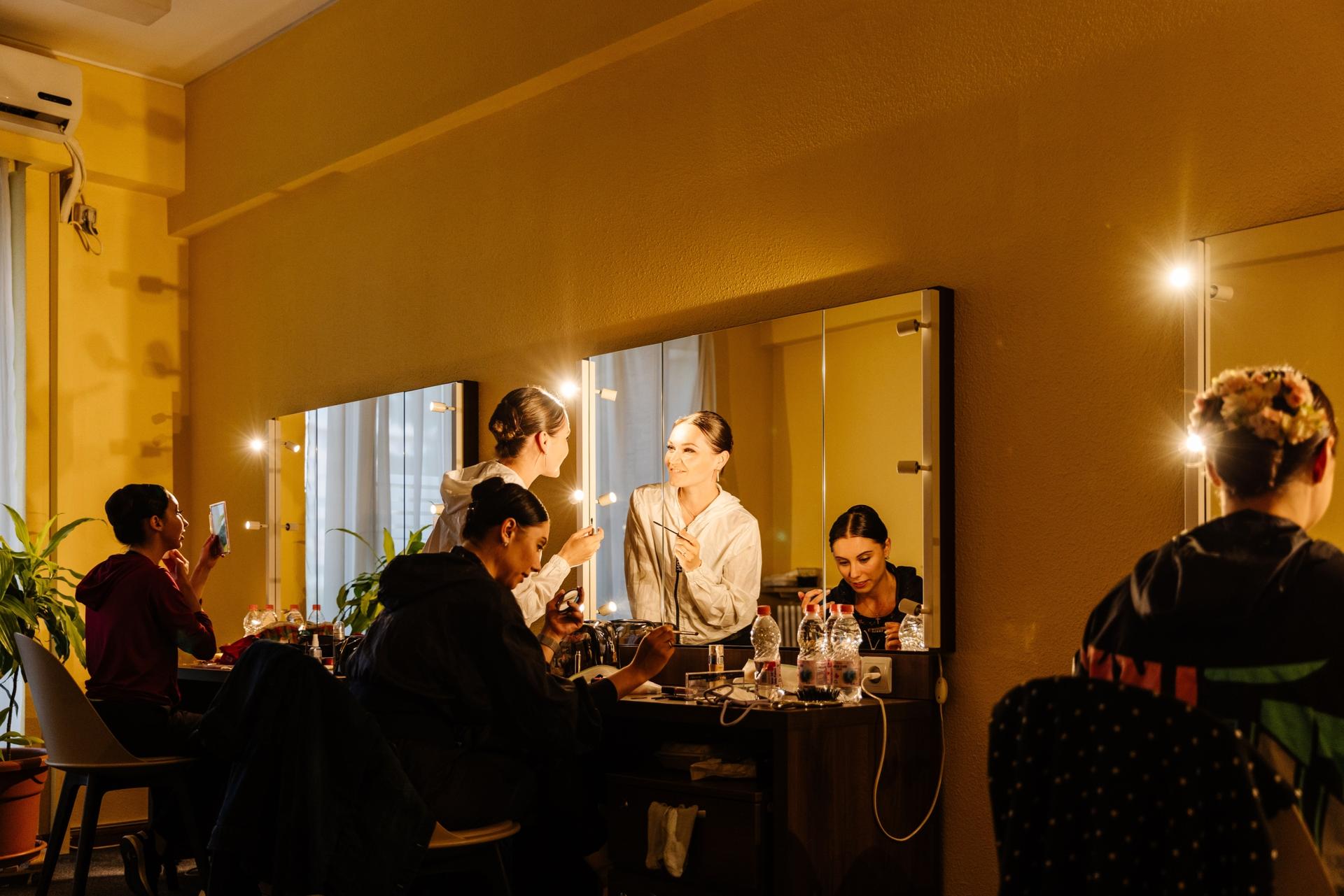 Ukrainian Classical Ballet dancers apply makeup in dressing room backstage before the performance in Bucharest, Romania.