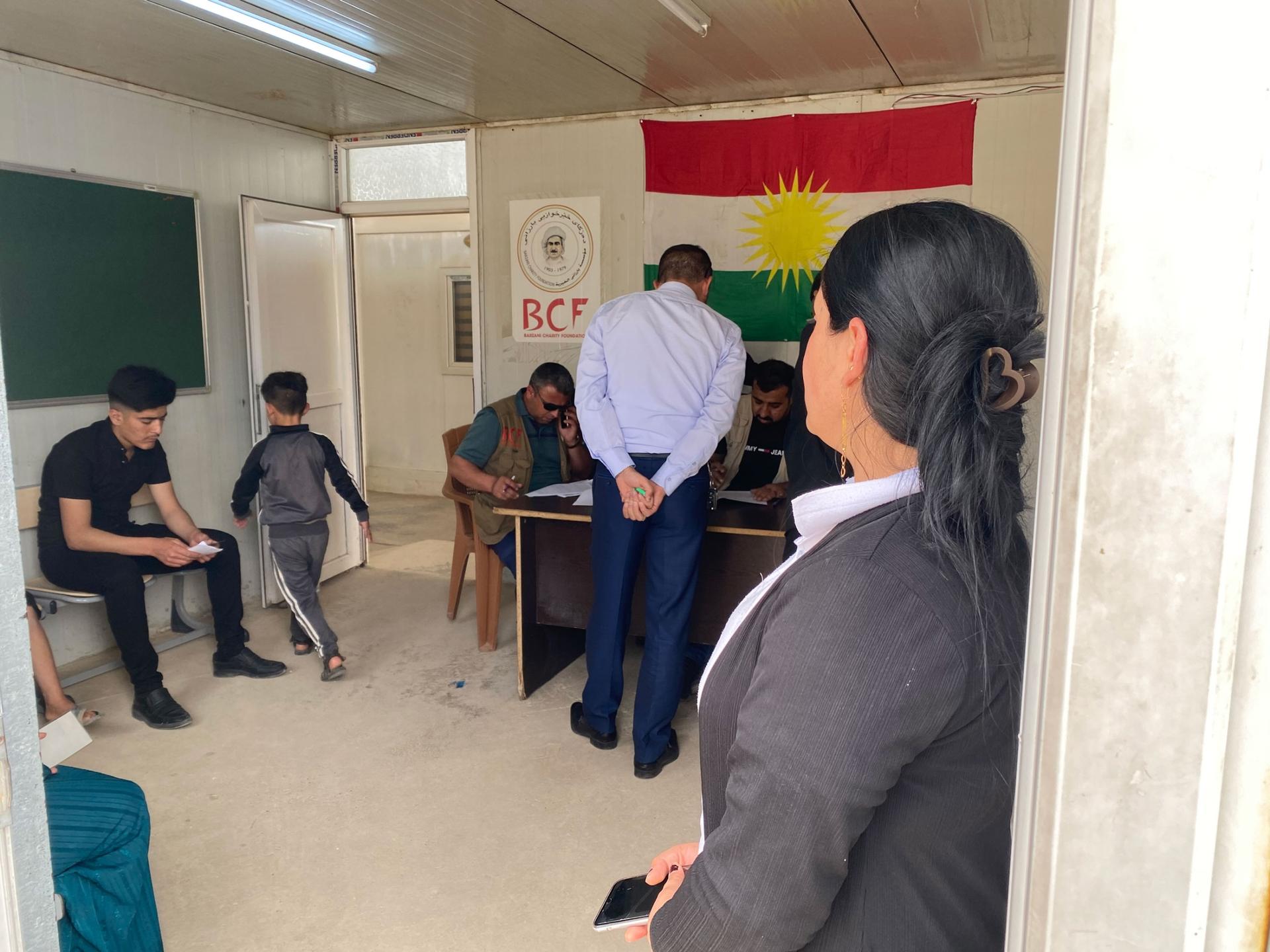 Shami Murad stands waiting for her turn to register for food aid at Sharya camp’s registration office, days after fleeing fighting in Sinjar. 