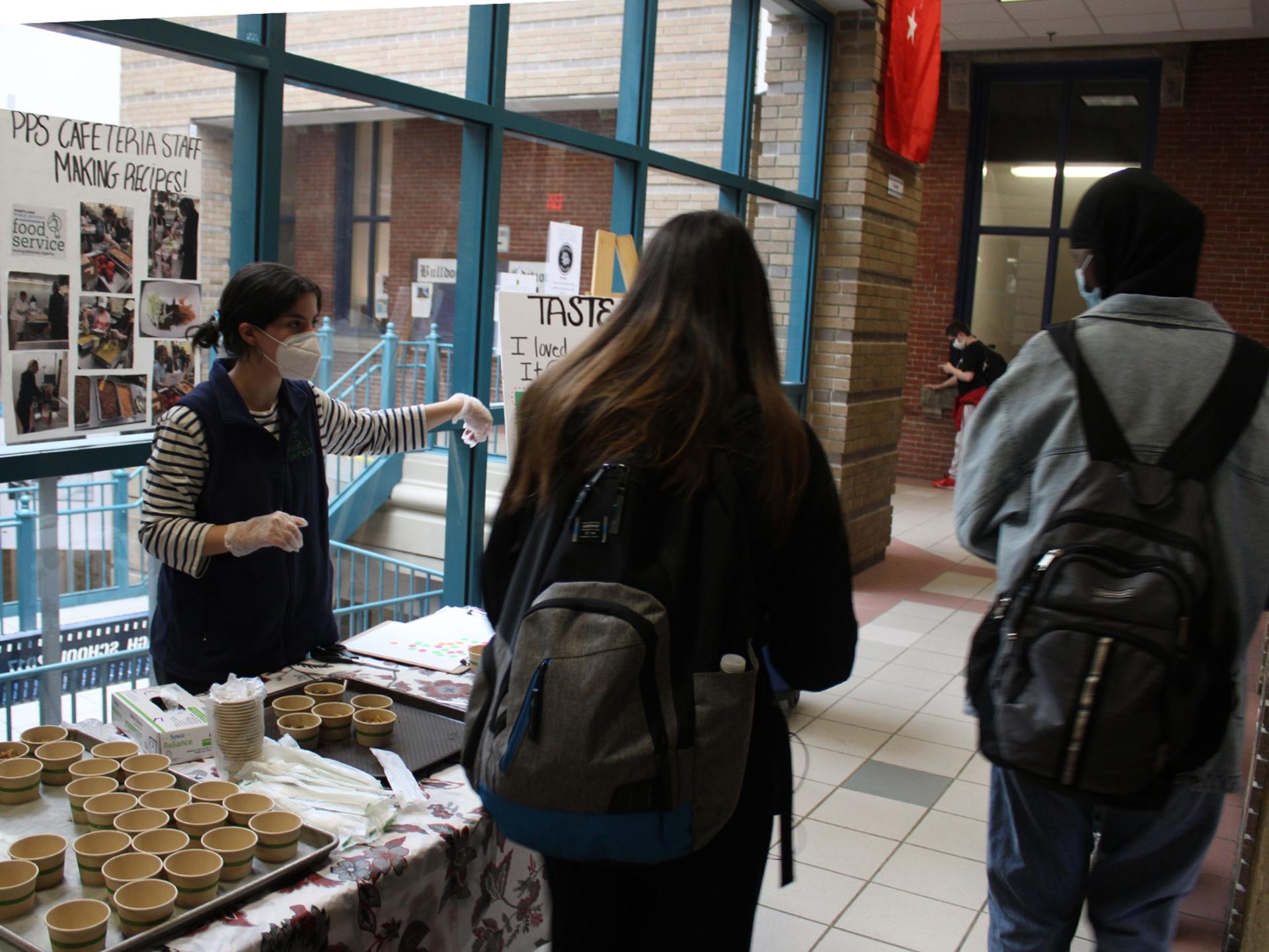 Zoe Grodsky, left, with the Cumberland County Food Security Council, talks with students at Portland High School during the final taste-testing event of the semester.
