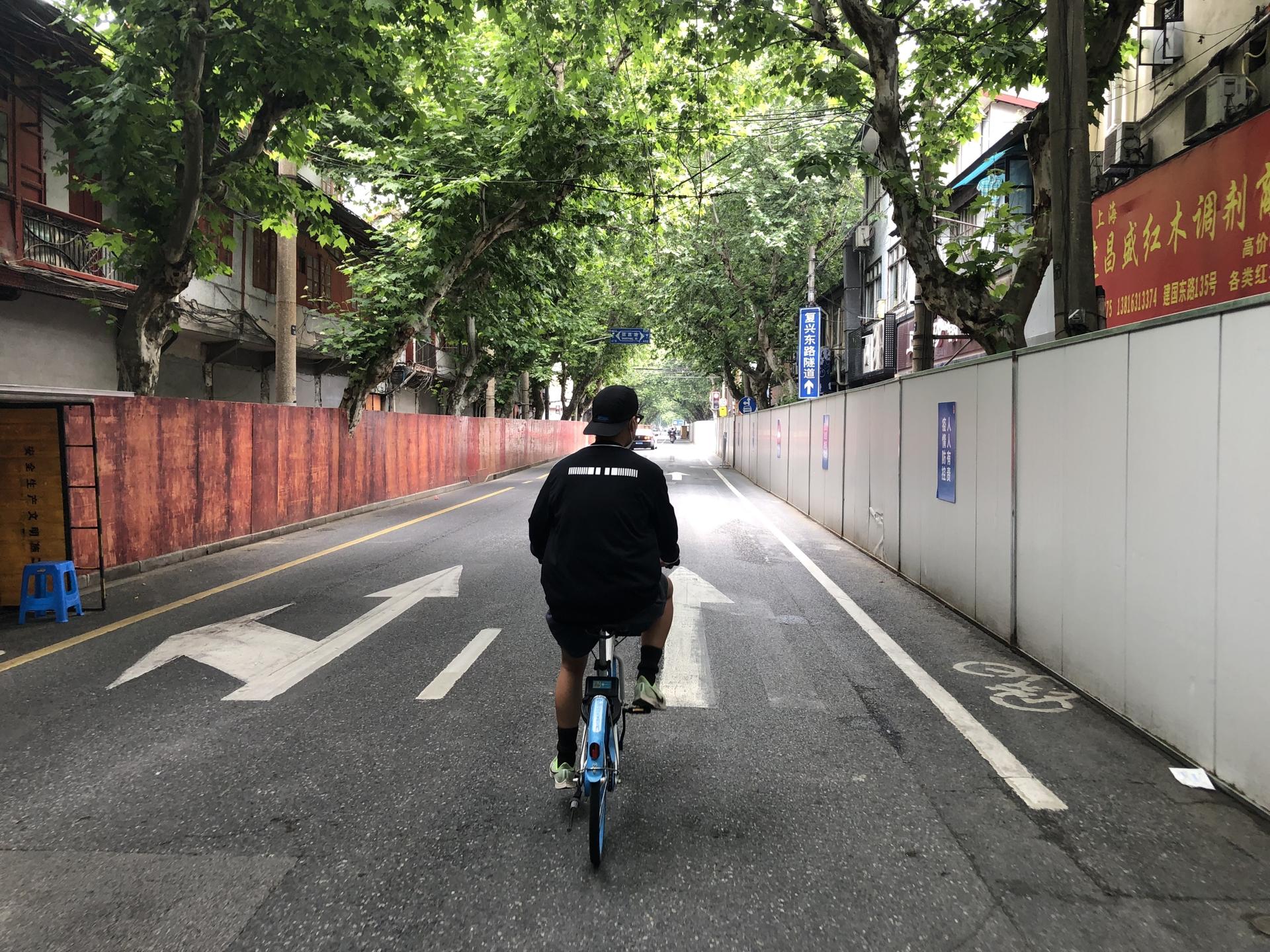 A bicyclist is seen riding through sealed-off streets of Shanghai