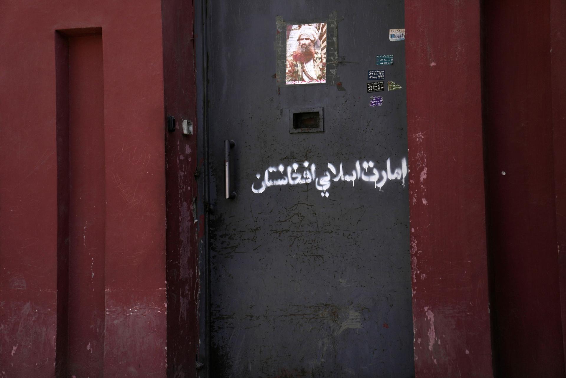 "Afghanistan Islamic Emirate," is written on the main entrance of the Music Institute, in Kabul, Afghanistan, Sunday, Feb. 20, 2022. 