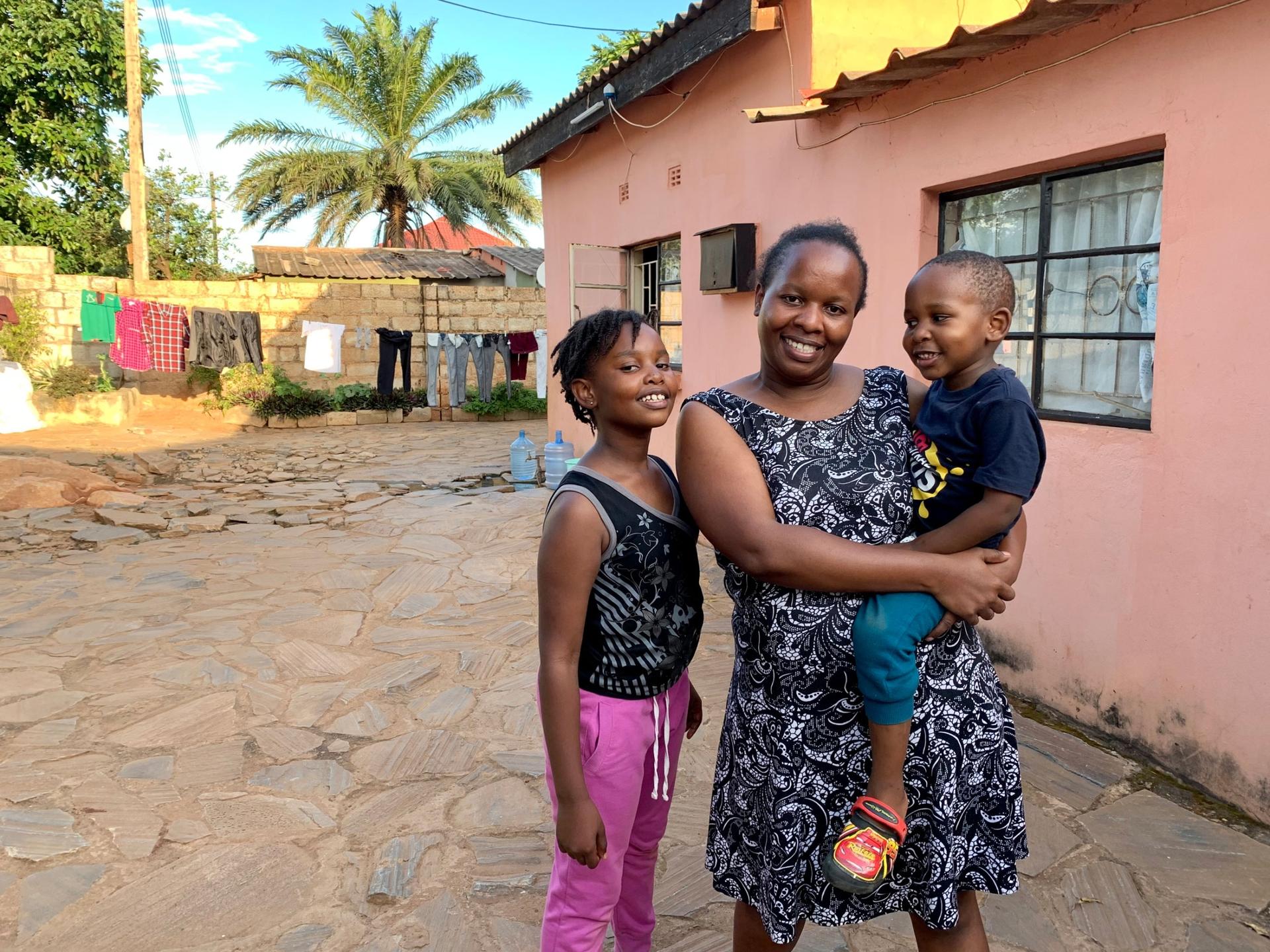 Nala Phiri was diagnosed with multiple sclerosis in 2016 after three years of unexplained symptoms. She is pictured here with her children Namila and Sangu outside of their home in Lusaka, Zambia.