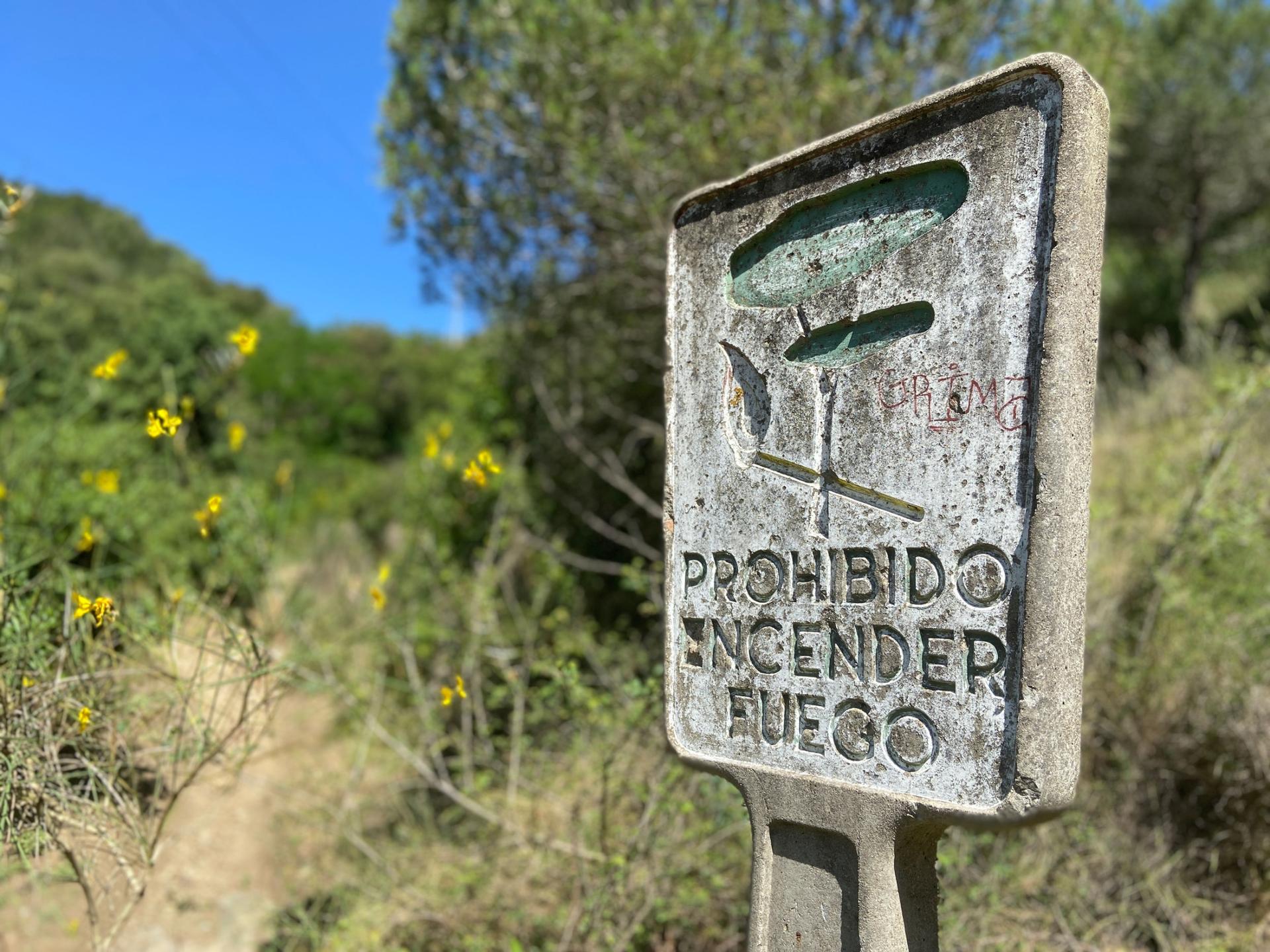 A sign in Barcelona's Collserola Park reads "No lighting fires." The summer is about to begin and people across Spain are expecting an increase in fires with the high temperatures.