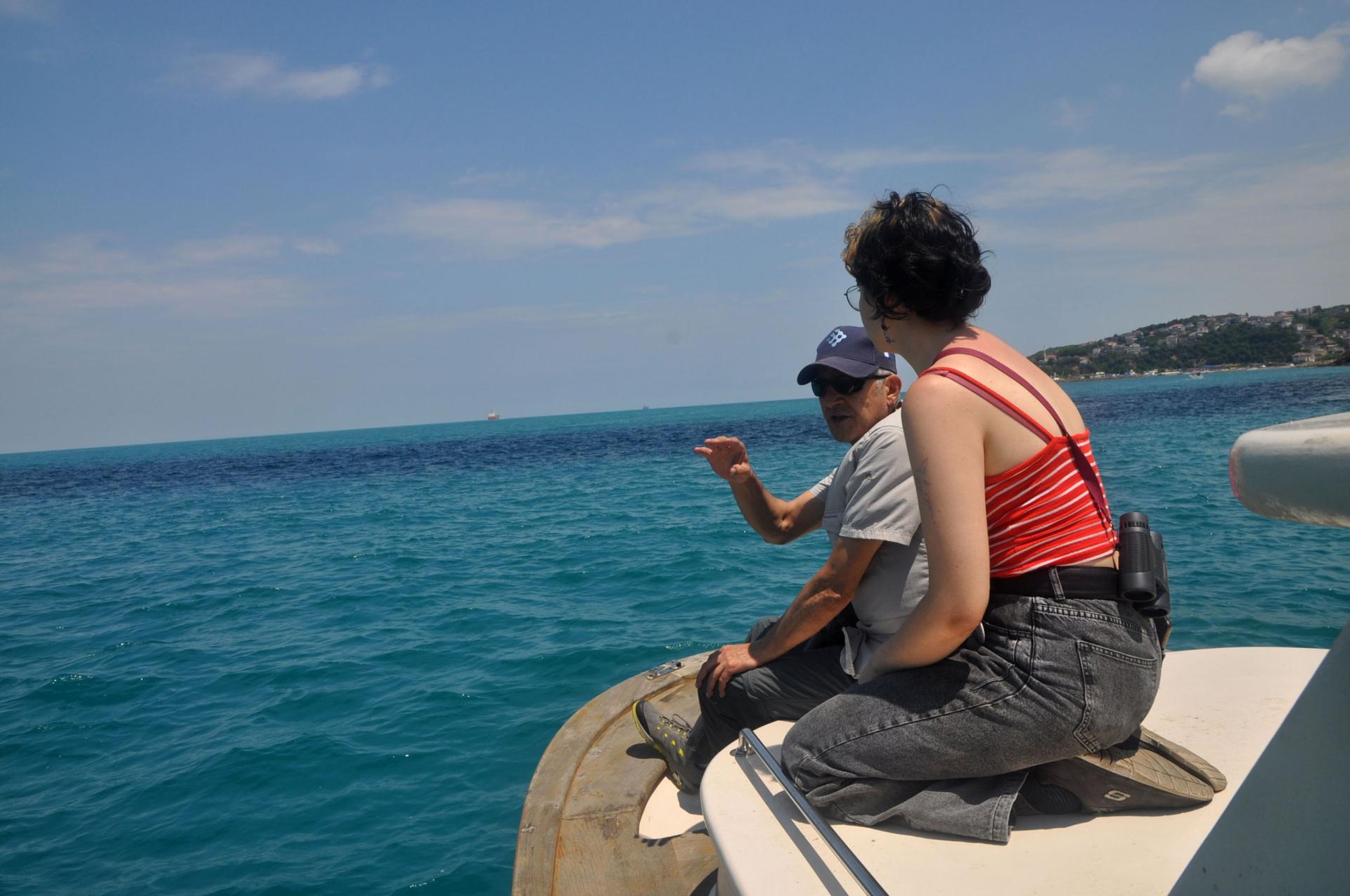 Marine biologist Ayhan Dede and doctoral student Aylin Güler keep an eye out for dolphins on a survey trip in the Bosphorus Strait.