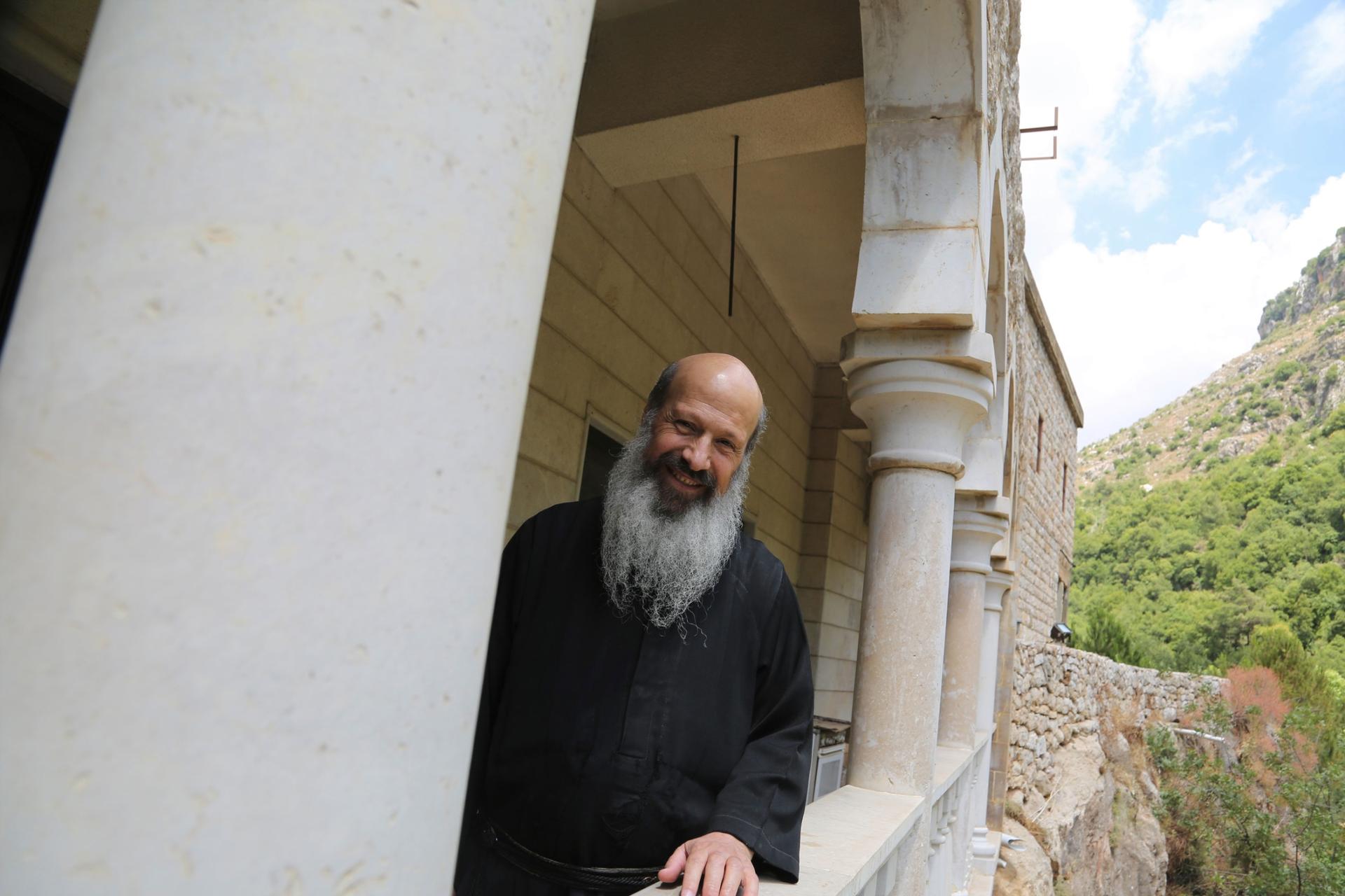 Father Kamil Kayrouz, a monk, looks out from a balcony at the Monastery of St. Anthony of Qozhaya. The nearby mountains were once blanketed with ancient cedar forests, before centuries of logging destroyed nearly all of them. 