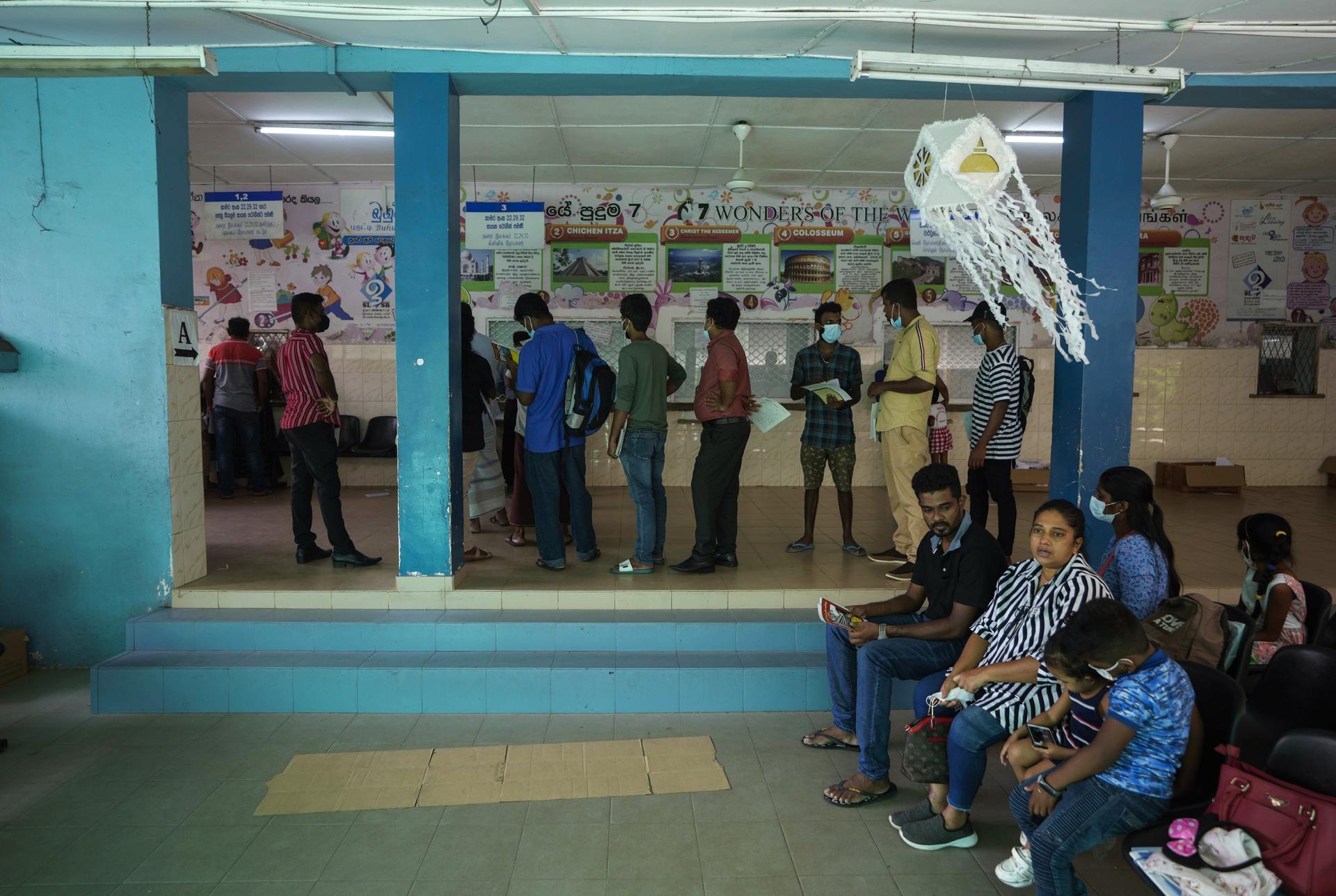 People wait to receive medicine at a pharmacy in a government hospital for children in Colombo, Sri Lanka