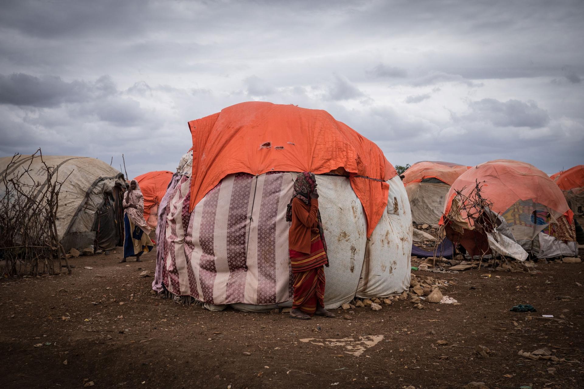Woman stands in a camp for internally displaced people in Baidoa, Somalia.
