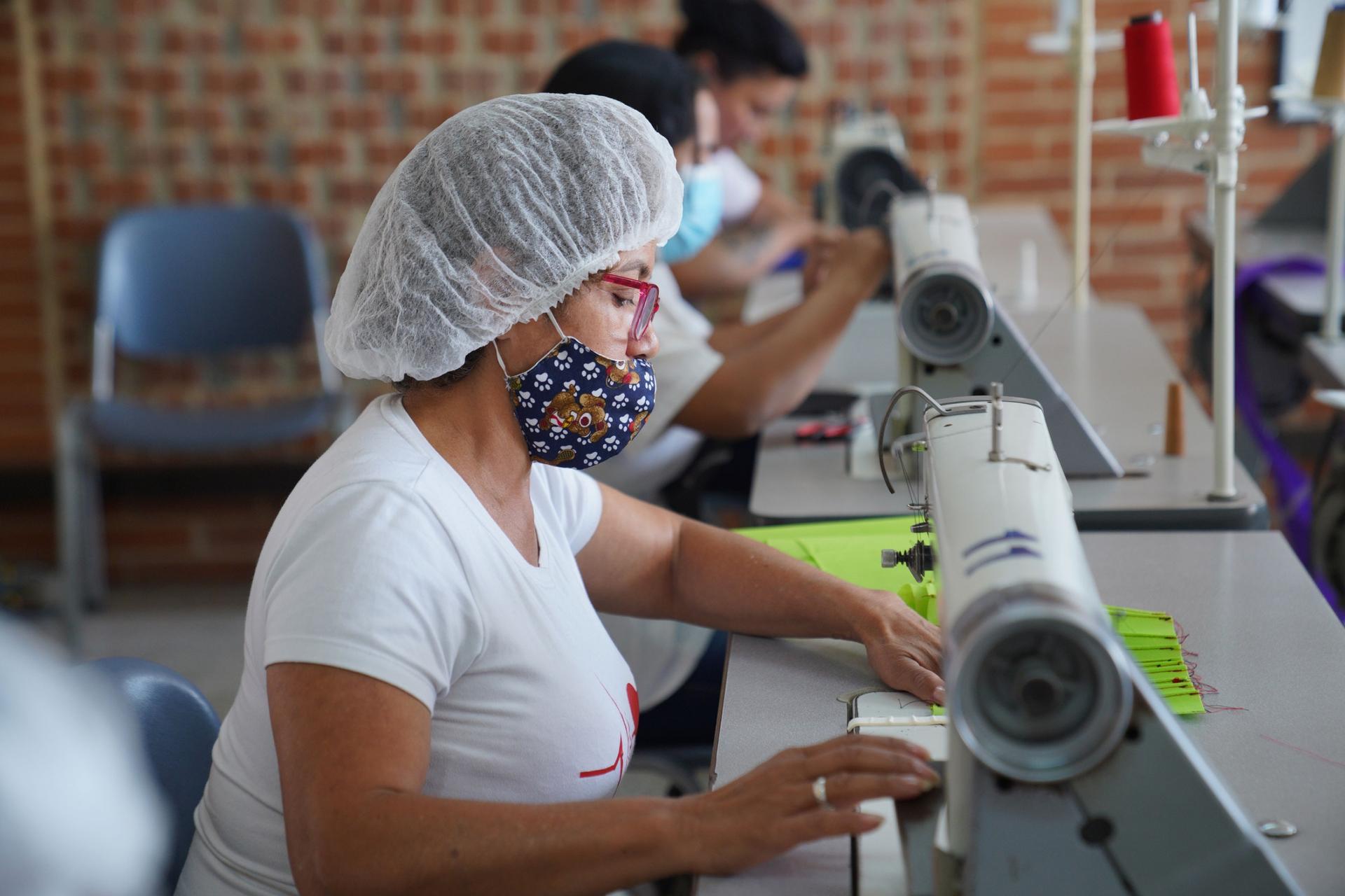 Women learn how to make clothes and use sewing machines at the careblock in the Bogotá suburb of Usme. 
