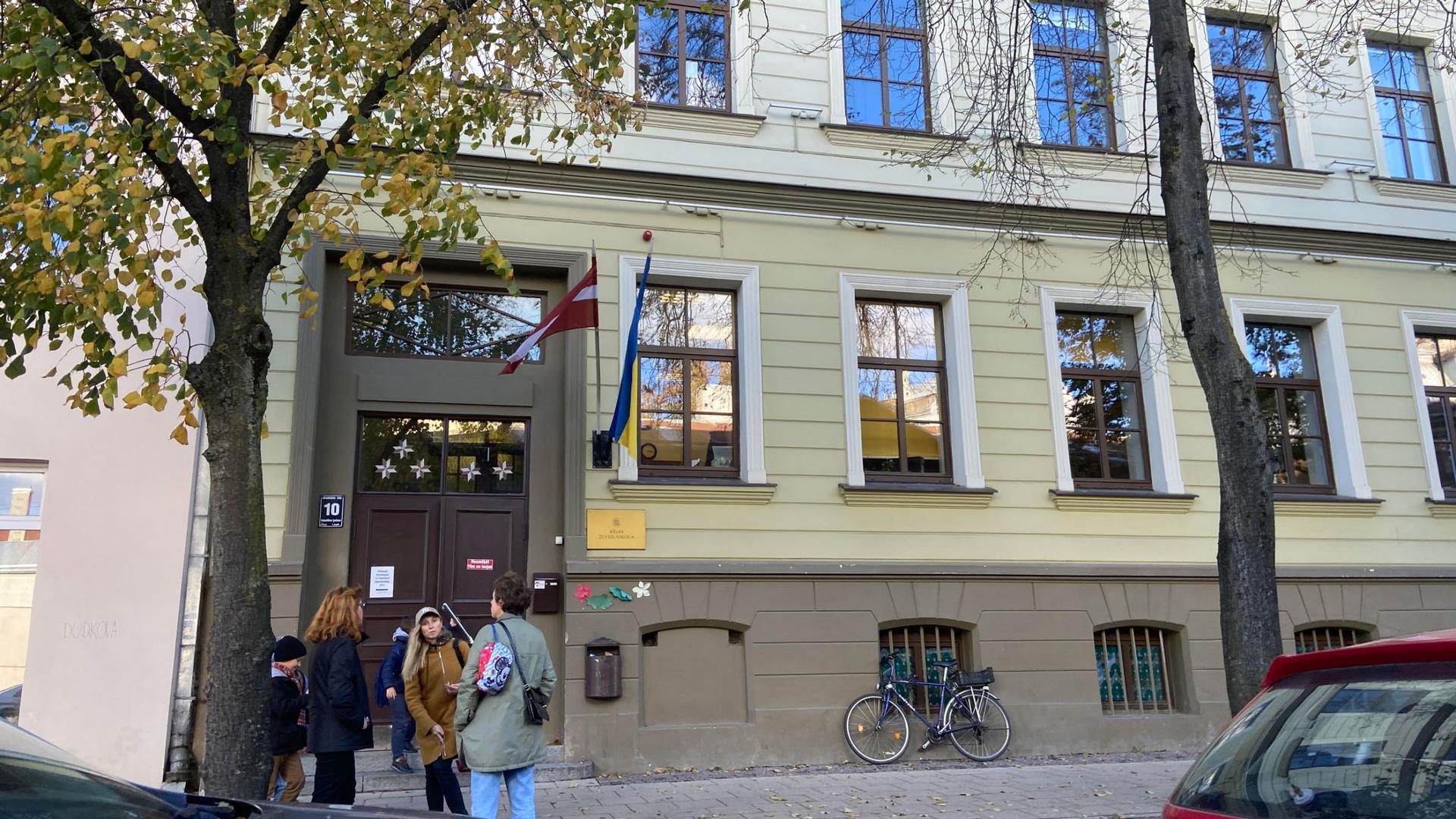Russian-speaking parents wait outside Russian School Number 22, in Latvia’s capital, Riga. They say there aren’t enough native Latvian teachers to help their kids transition from Russian to the official language.