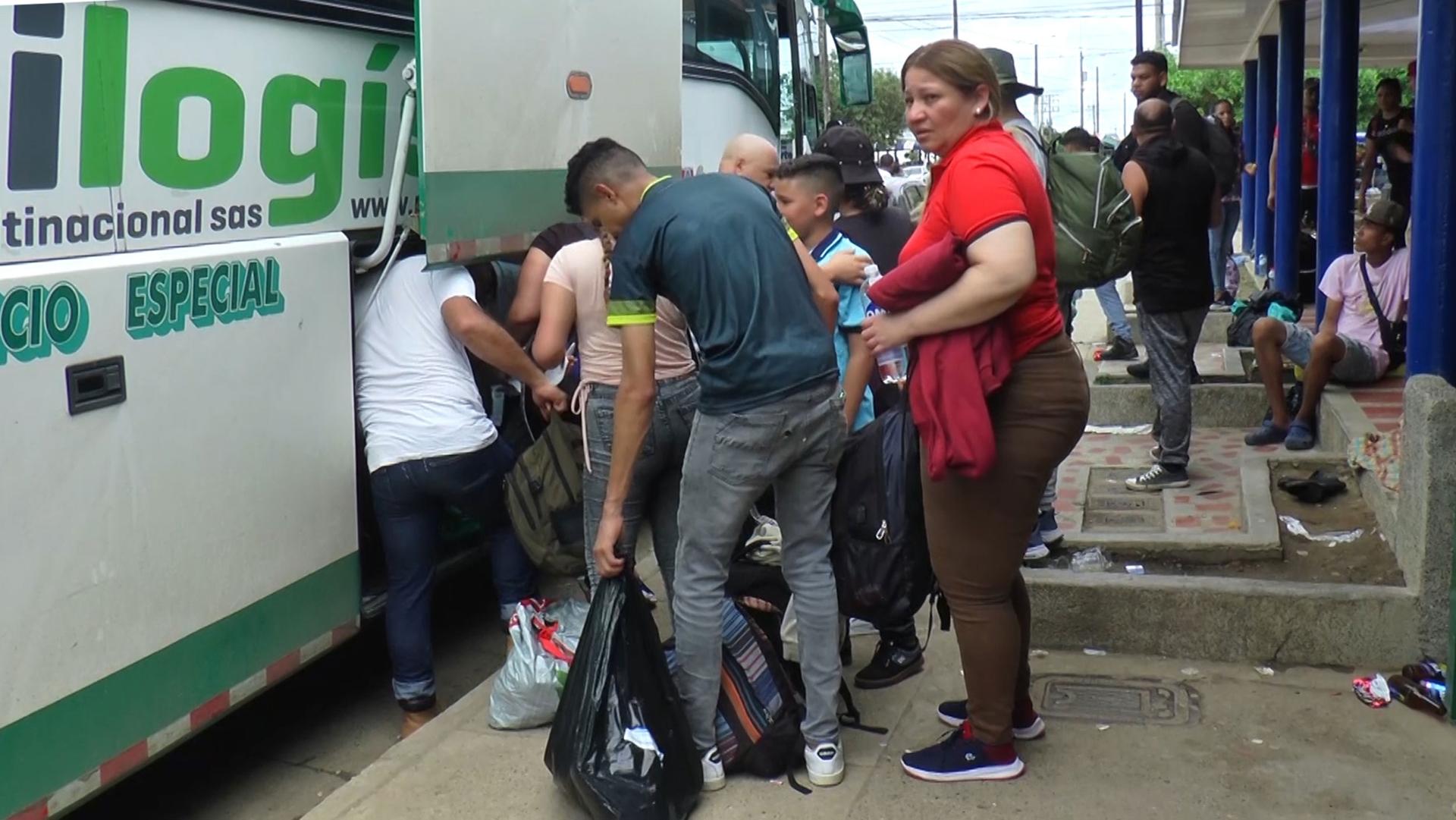 Venezuelan migrant Francis Rivero (in red) packed her bags onto a bus that took her back into central Colombia after the Biden Administration announced its new policy for Venezuelan asylum-seekers.