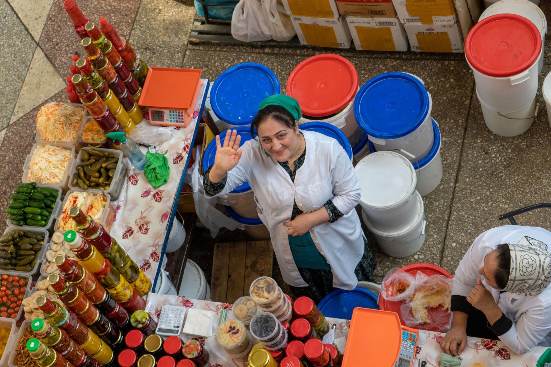 A vendor in the Green Bazaar smiles. 
