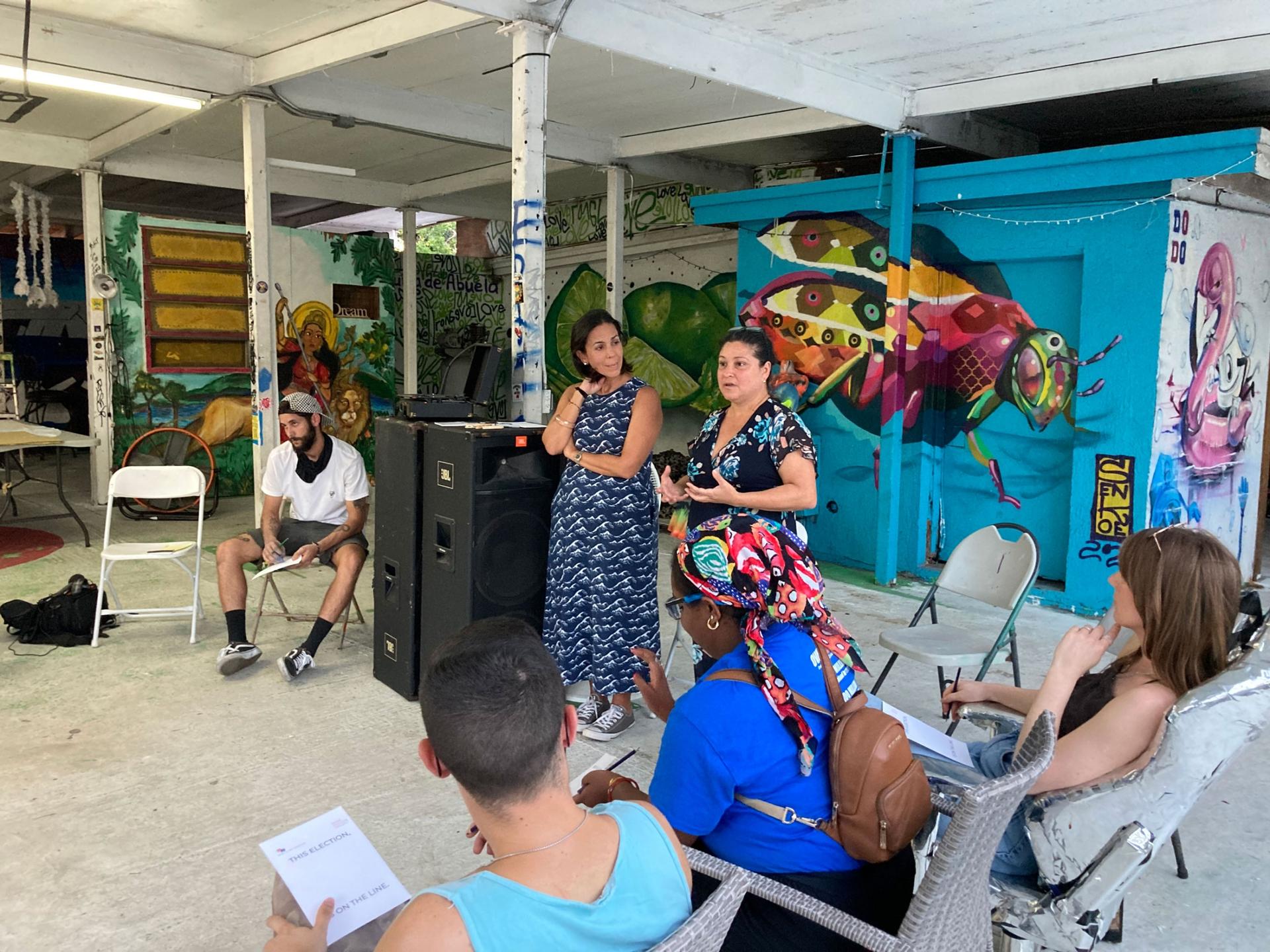 Ana Sofia Pelaez (in blue), founder of the Miami Freedom Project and Iris Ruiz (in black), Cuban artist and coordinator for the San Isidro movement lead an art workshop at La Esquina de Abuela, a cultural center in Miami. 