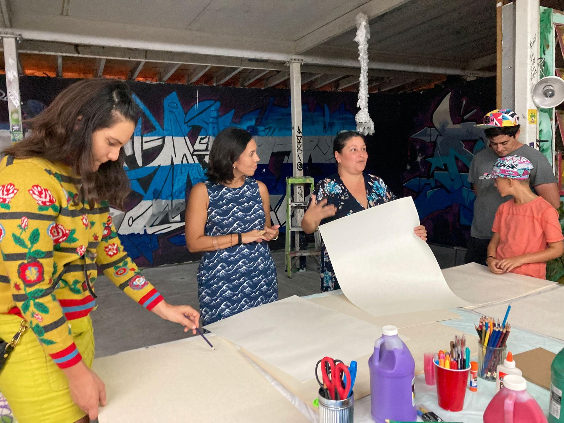 Ana Sofia Pelaez (in blue), founder of the Miami Freedom Project and Iris Ruiz (in black), Cuban artist and coordinator for the San Isidro movement lead an art workshop at La Esquina de Abuela, a cultural center in Miami.