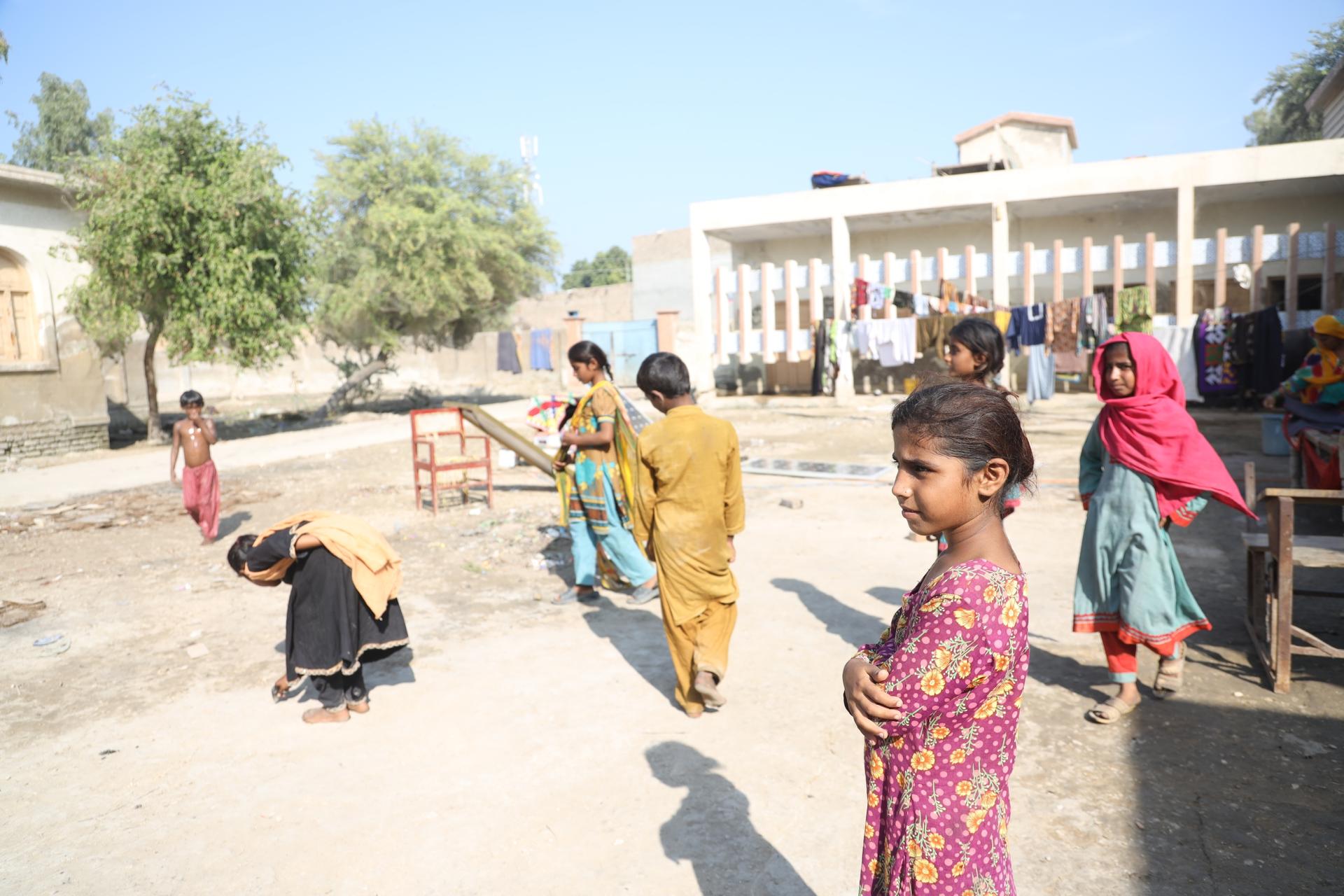 Children from Abdul Ghani’s own family and extended family play together in a courtyard in Pakistan.