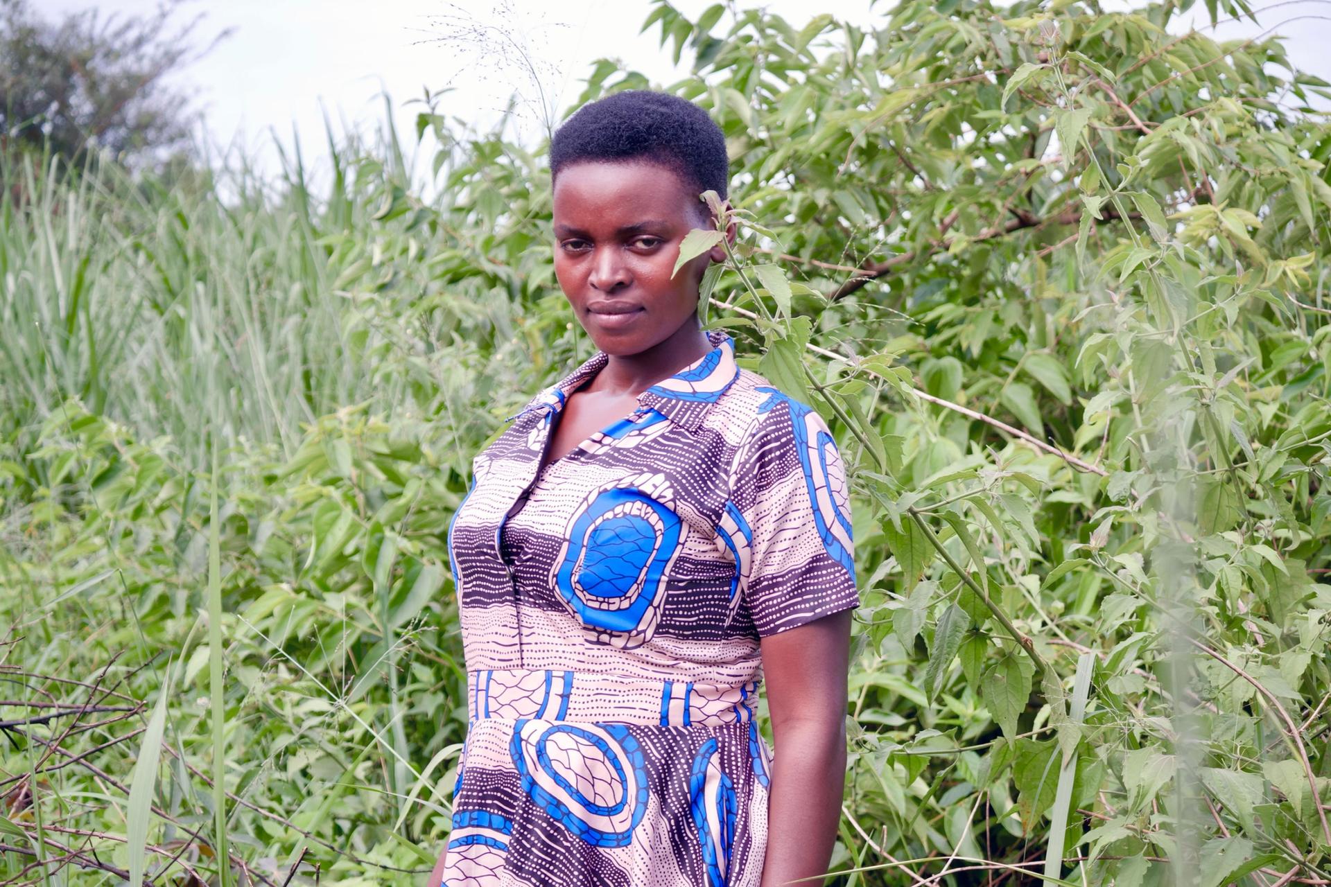 Rachel Tugume in front of her land that she was ordered to sell to EACOP to make room for the oil pipeline. She continues to negotiate for a fairer settlement. 