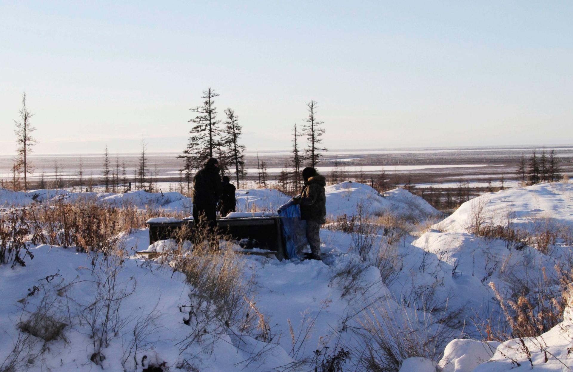 In this Oct. 27, 2010 file photo, Russian scientists Sergey Zimov and his son Nikita Zimov extract air samples from frozen soil near the town of Chersky in Siberia, 4,000 miles east of Moscow, Russia. 