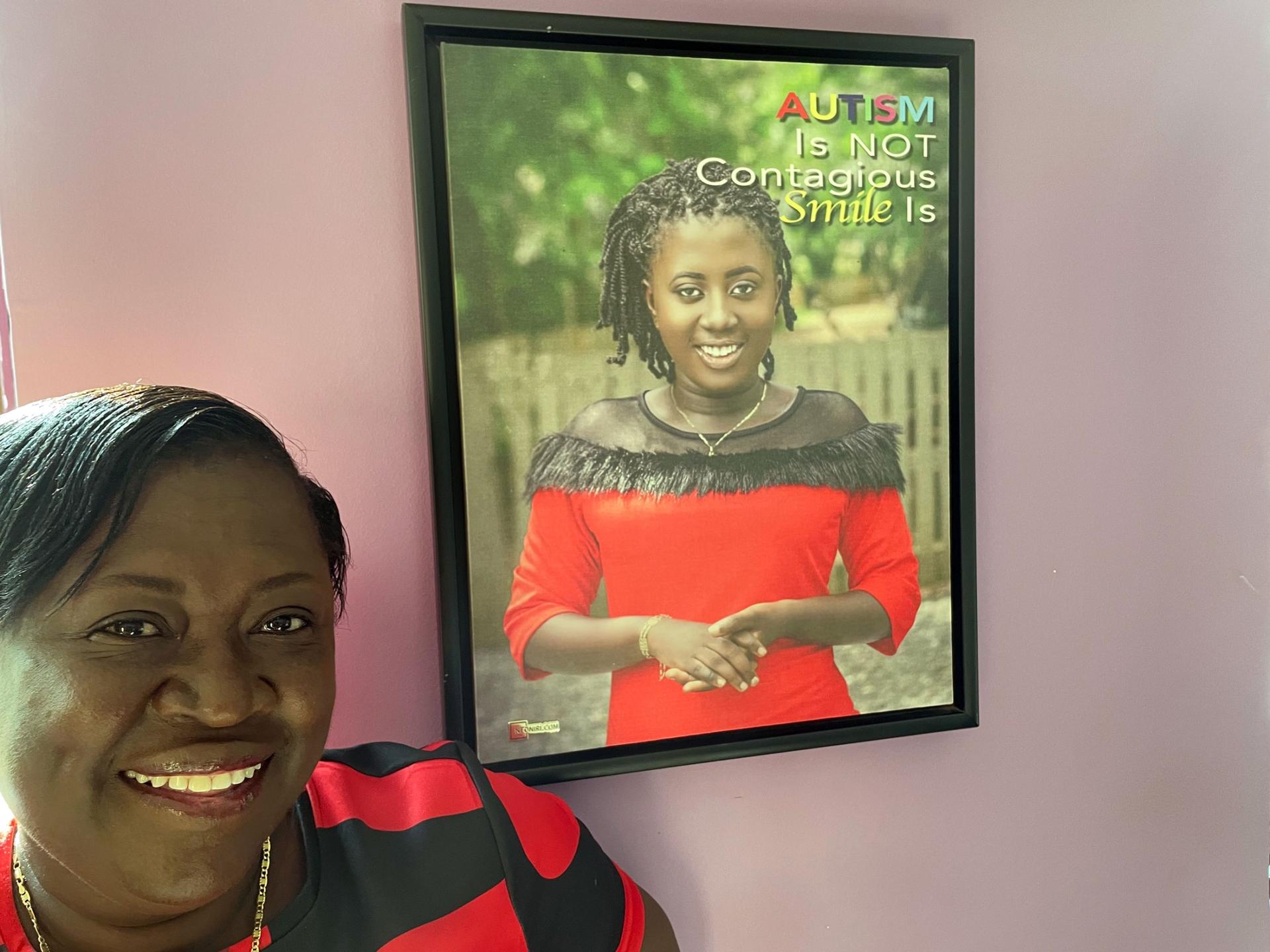 Mary Kufuor, founder of Klicks Africa Foundation, stands by a portrait of her autistic daughter, Nana Yaa. 