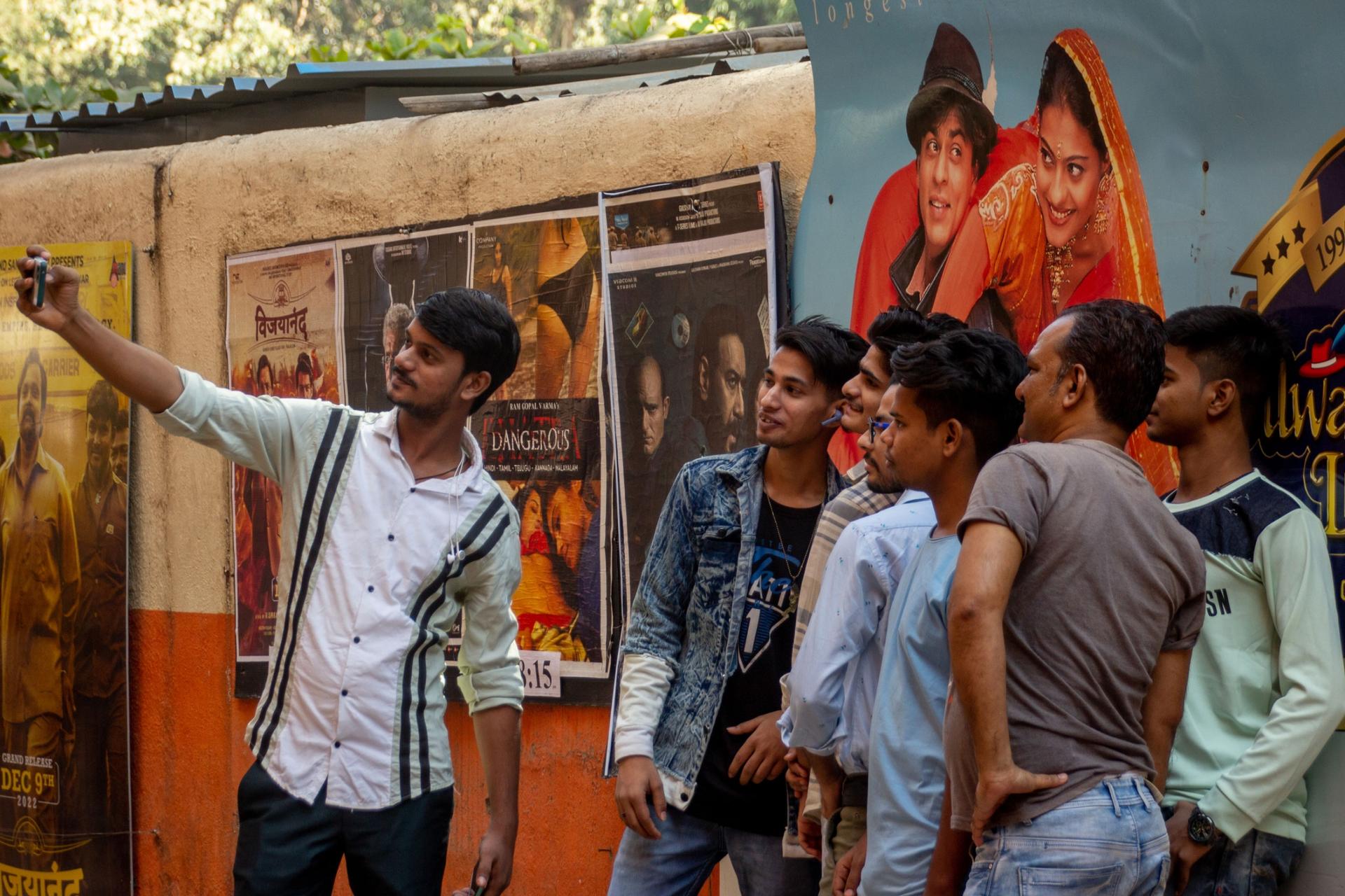 Moviegoers take a selfie with the iconic DDLJ poster. 