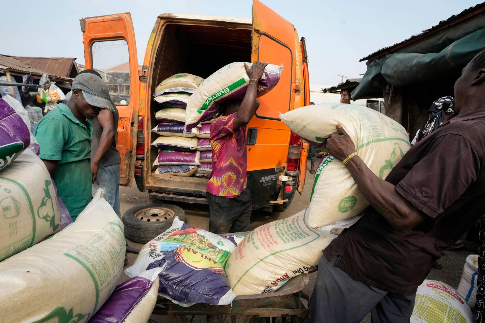 Workers loads bags of rice into a truck at a market in Lagos, Nigeria Tuesday, Feb. 7, 2023. 