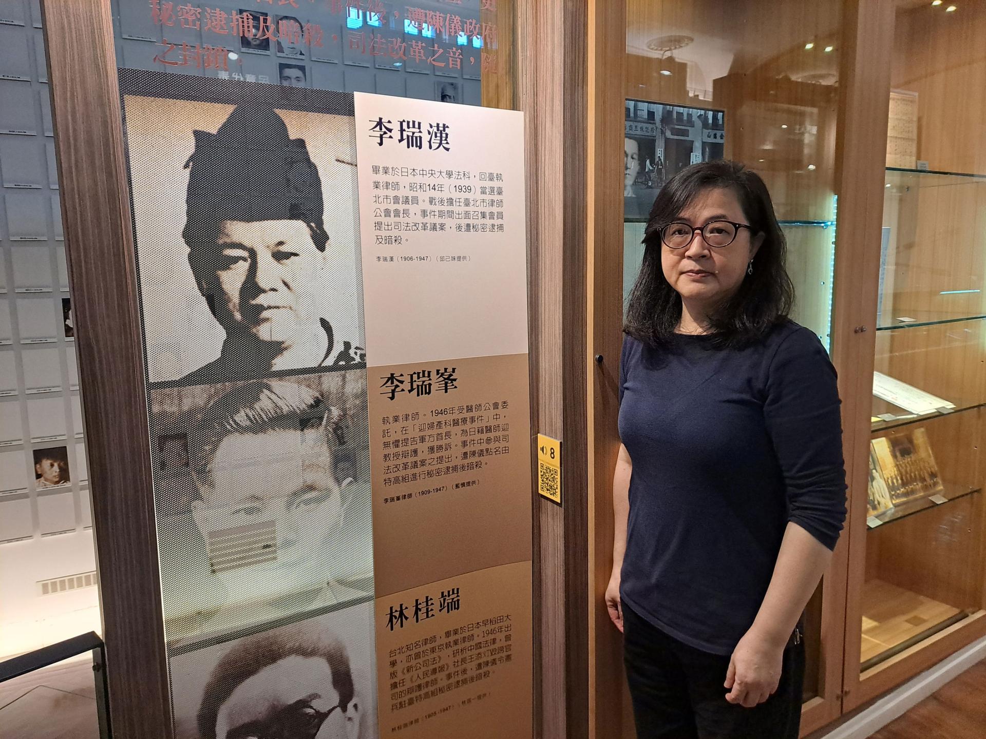 Amy Lee stands next to a photo of her grandfather, Lee Ruei-Han, a prominent lawyer who was killed during the 228 massacre. 