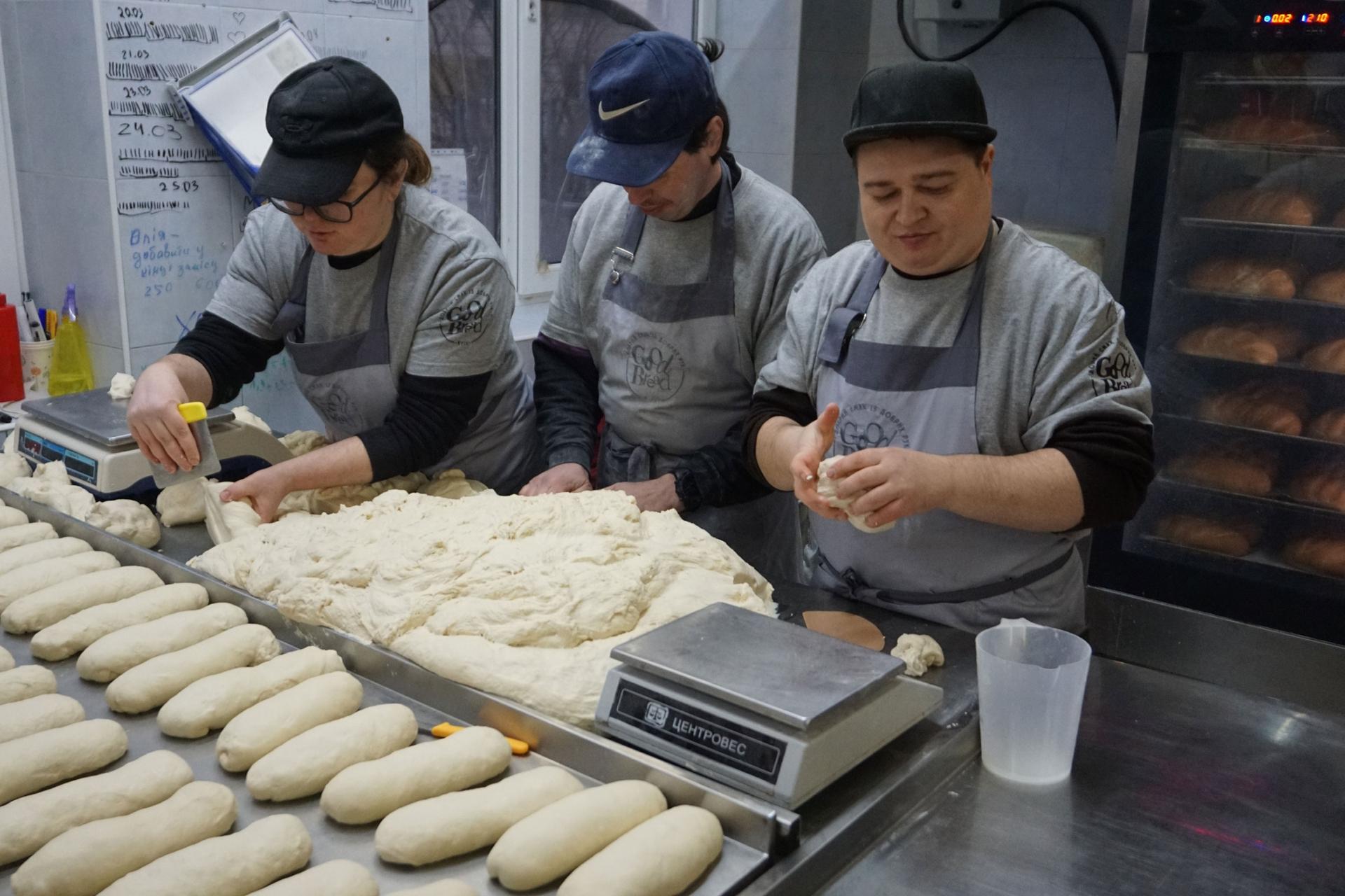 Volunteers at Good Bread Bakery knead dough for loaves of bread for soldiers and civilians living in areas near the front lines. 