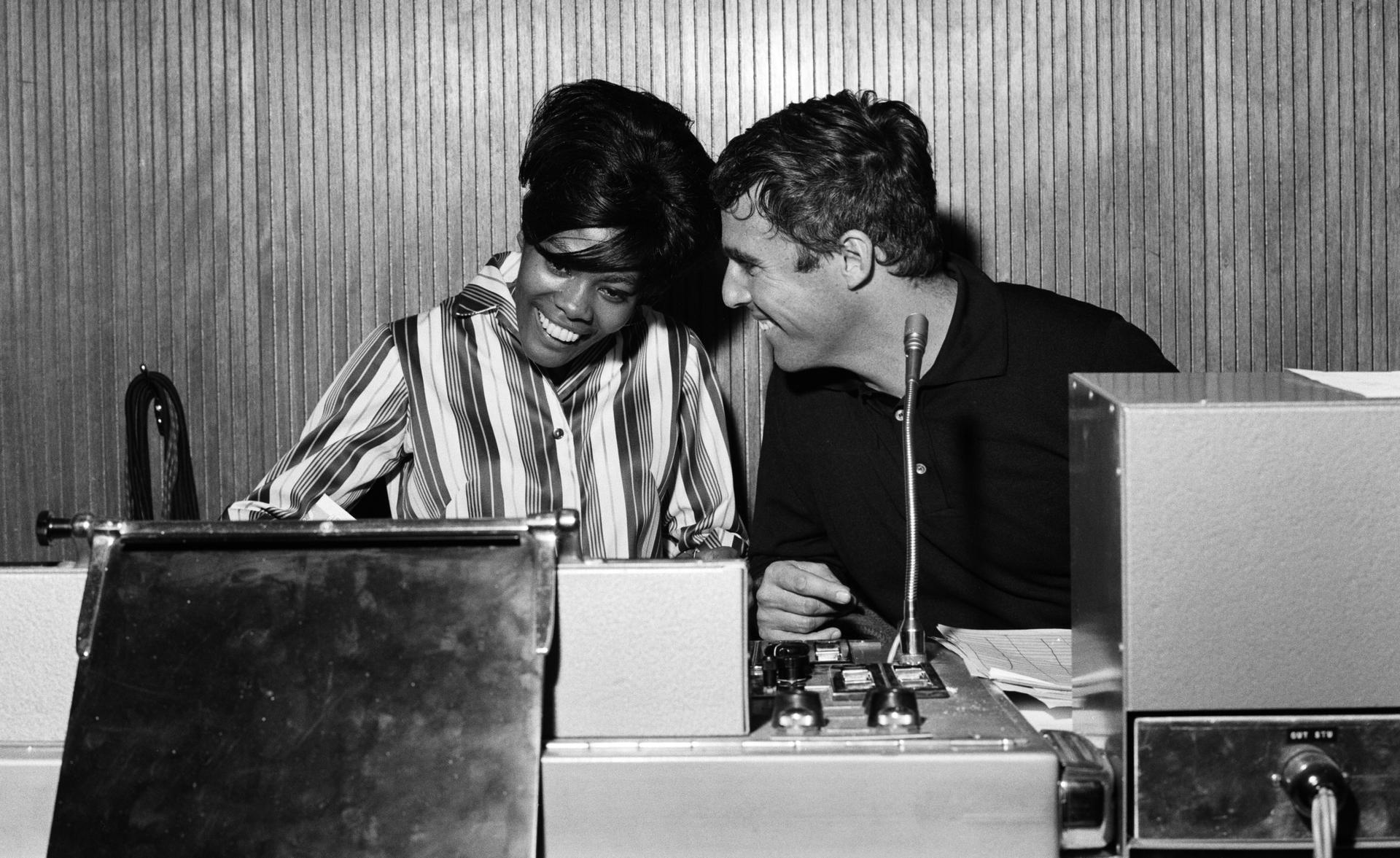 A man and a woman sitting at a recording console