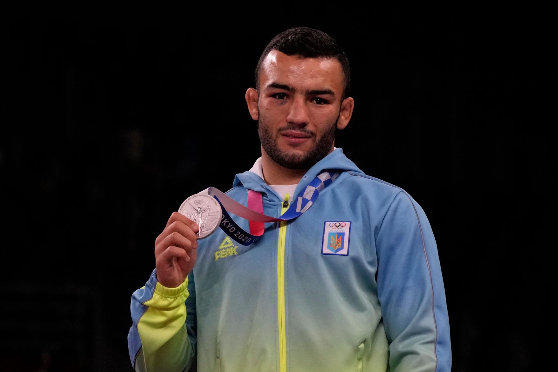 Silver medalist, Ukraine's Parviz Nasibov celebrates on the podium during the medal ceremony for the men's 67kg Greco-Roman wrestling at the 2020 Summer Olympics, Wednesday, Aug. 4, 2021, in Chiba, Japan. 