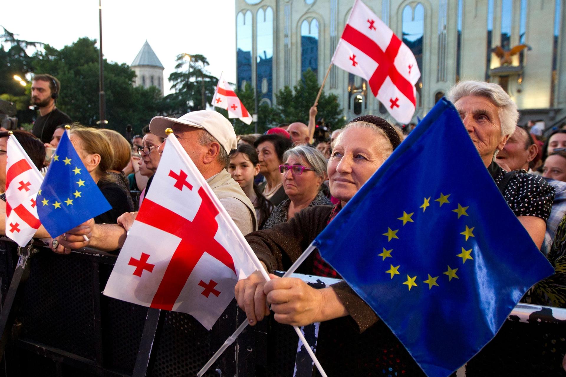 Demonstrators gather with Georgian national and EU flags during a pro-EU and anti-government rally 