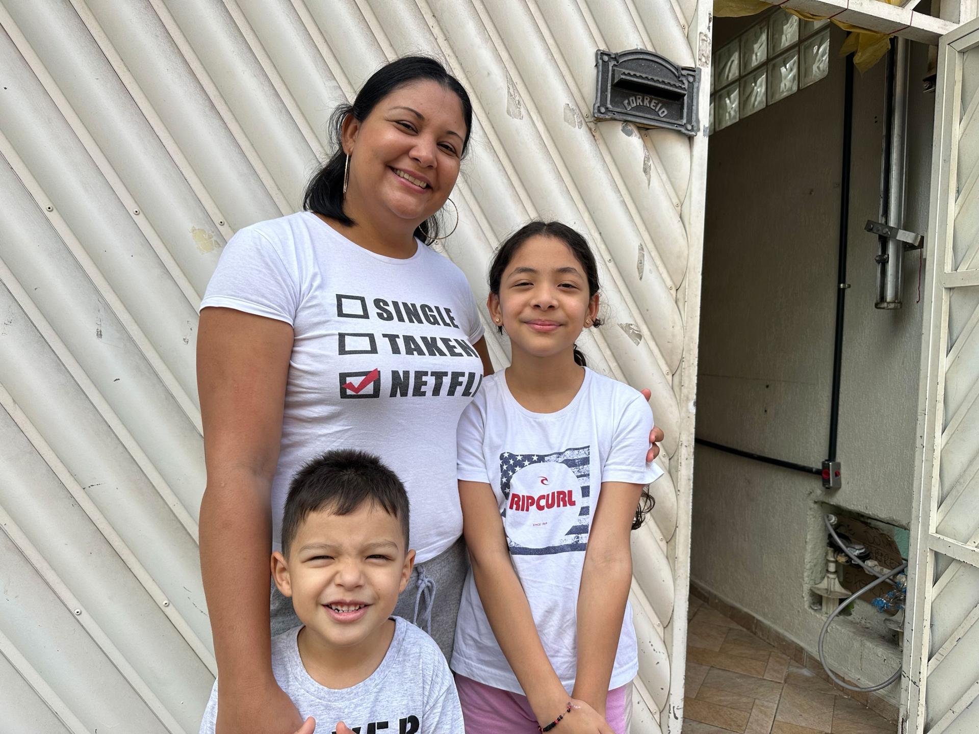 Yoselin Calcurian with her youngest son Josué, 4, and daughter Sofia, 9, in front of their one-bedroom apartment in Vila Natal that they converted into a two-bedroom. 
