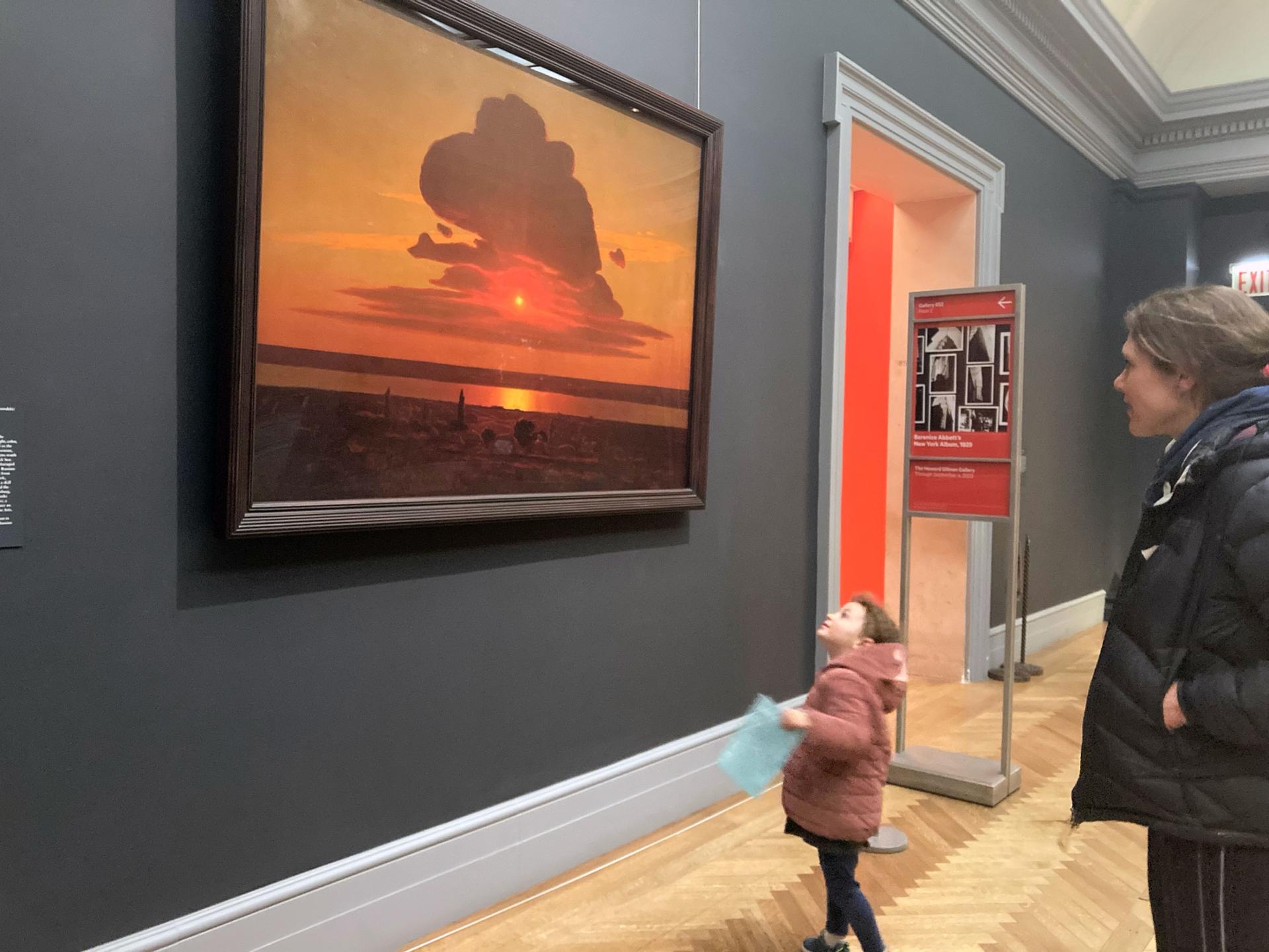 Visitors take in the painting "Red Sunset" at the Met. 